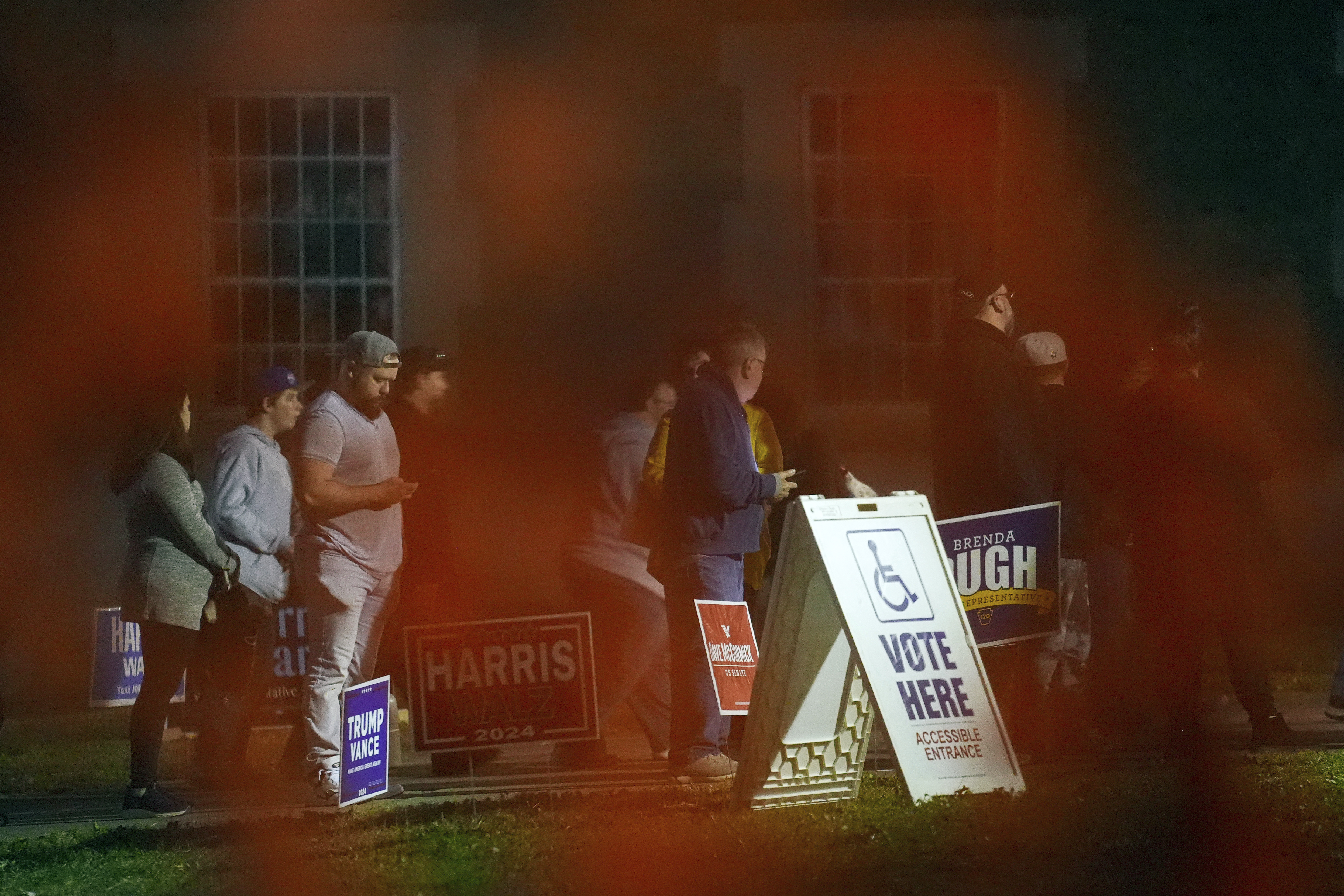 Voters wait in line to cast their ballots at the Kingston Armory in Wilkes-Barre, Pa, Tuesday, Nov. 5, 2024. (AP Photo/Matt Rourke)