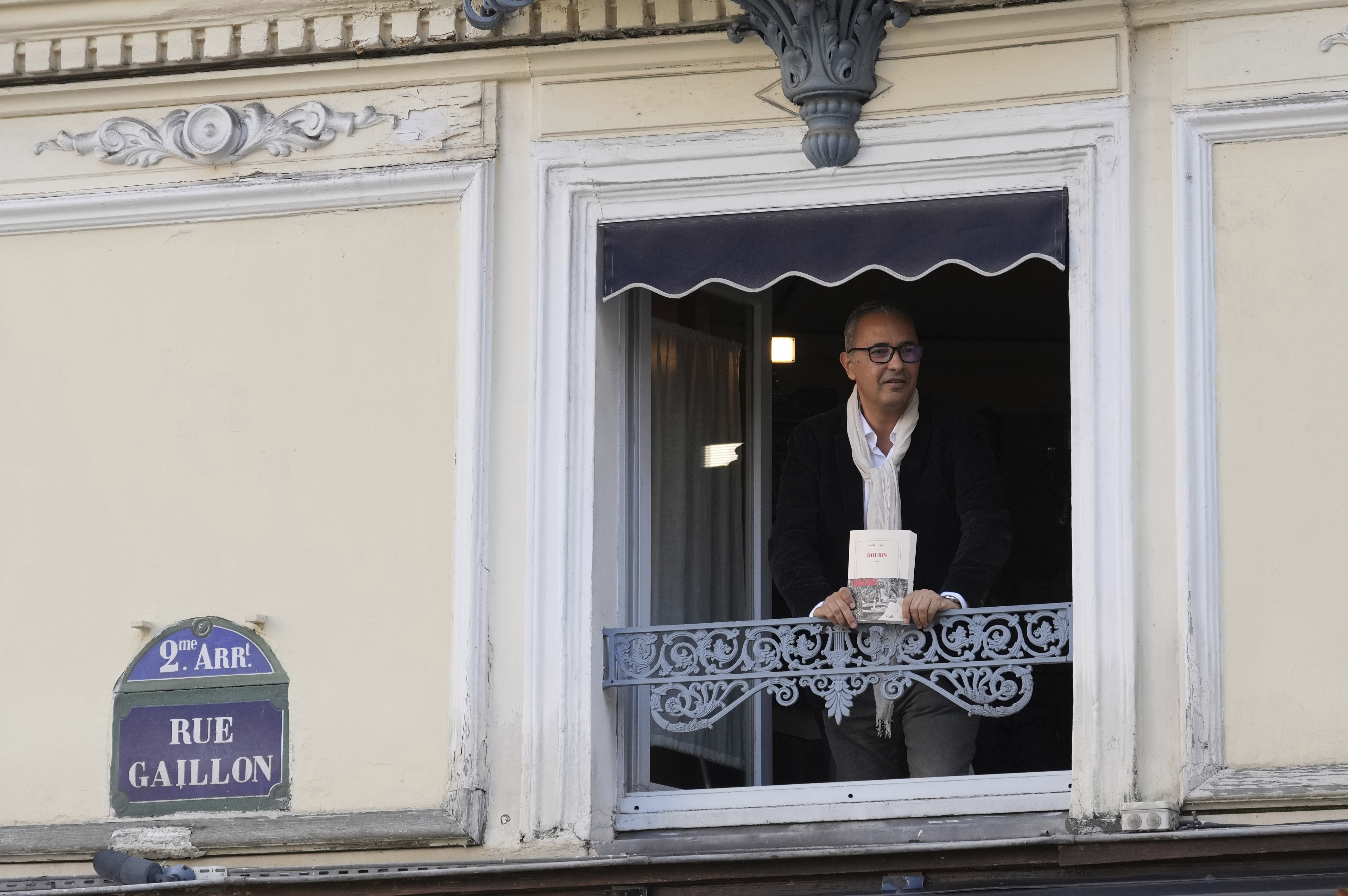 Algerian-French novelist Kamel Daoud holds his book Houris after being awarded with the Goncourt, France's most prestigious literary prize, Monday, Nov. 4, 2024 in Paris. (AP Photo/Aurelien Morissard)