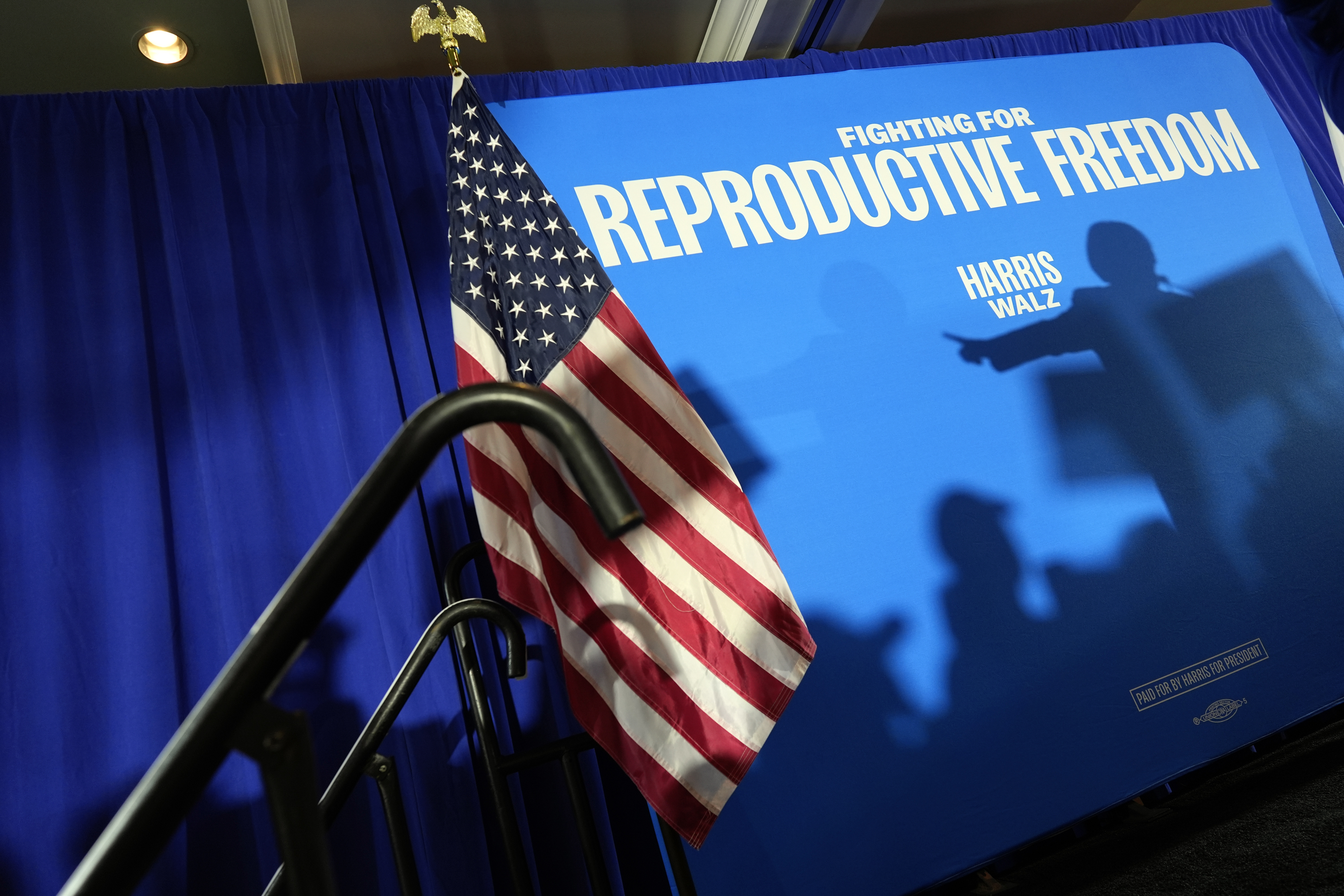 FILE - The shadow of Sen. Amy Klobuchar, D-Minn., is cast on a backdrop as she speaks at an event kicking off a national "Reproductive Freedom Bus Tour" by the campaign of Democratic presidential nominee Vice President Kamala Harris and running mate Gov. Tim Walz, Tuesday, Sept. 3, 2024, in Boynton Beach, Fla. (AP Photo/Rebecca Blackwell, File)