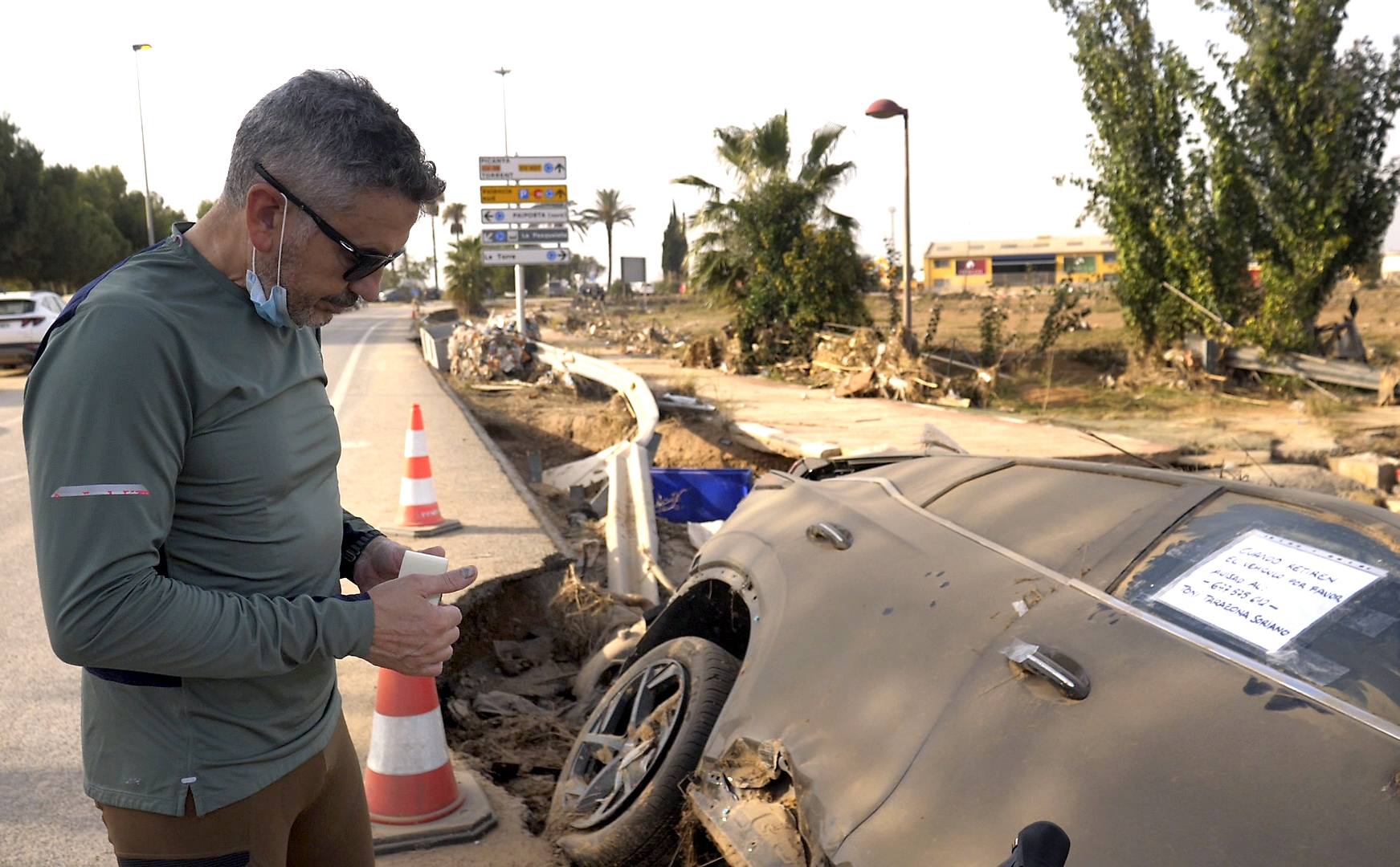 Jorge Tarazona stands next to a car in Paiporta, Valencia, Spain, Wednesday, Nov. 5, 2024, where his three-year-old niece and sister-in-law died in last week's floods in eastern Spain. (AP Photo/Paolo Santalucia)