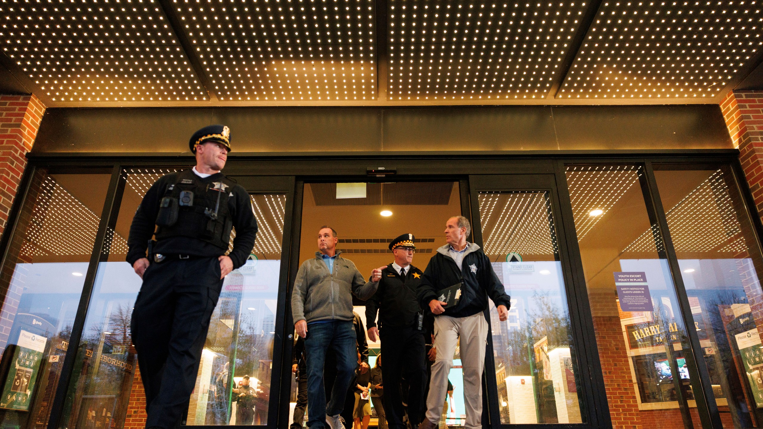 Police officials walk out to give a brief of a shooting at Navy Pier during a news conference outside the main entrance, Tuesday, Nov. 5, 2024 in Chicago. (Anthony Vazquez/Chicago Sun-Times via AP)