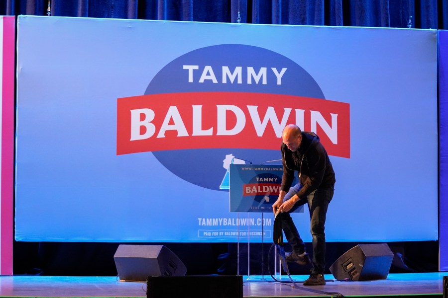 An employee breaks down items on a stage after an election night watch party for Sen. Tammy Baldwin, D-Wis., Wednesday, Nov. 6, 2024, in Madison, Wis. (AP Photo/Kayla Wolf)