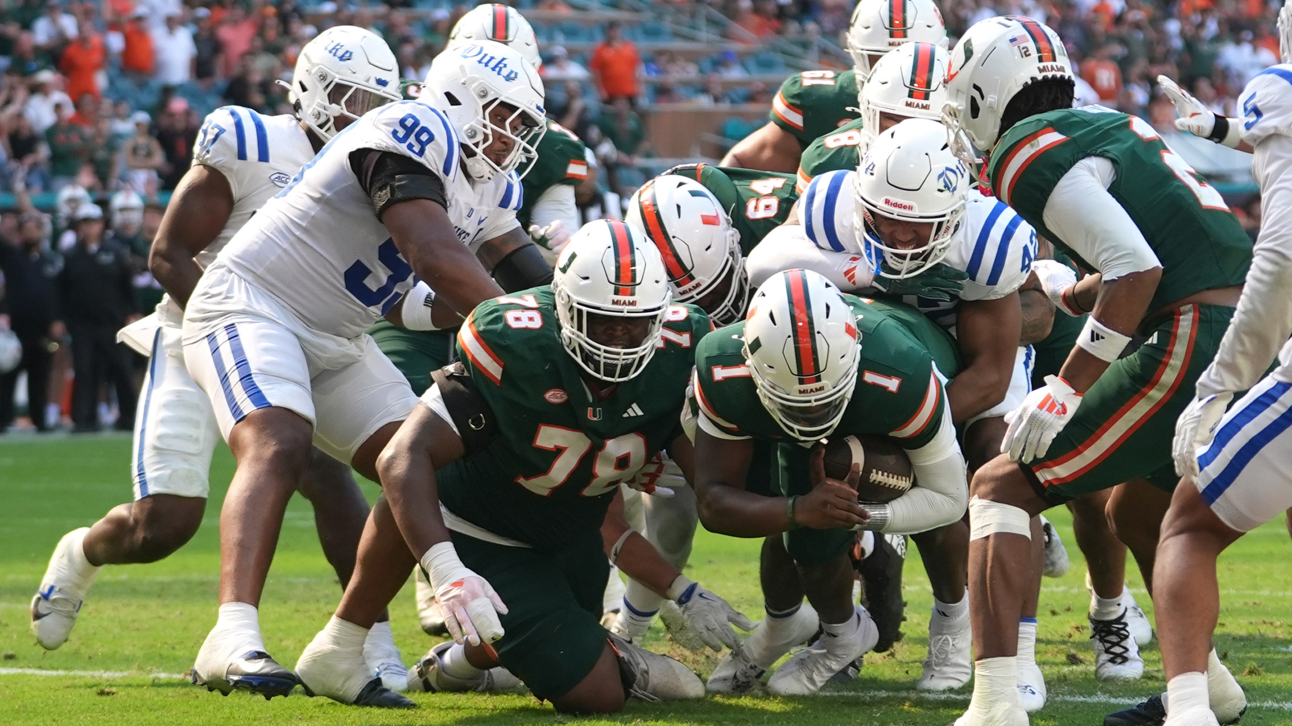 Miami quarterback Cam Ward (1) scores a two-point conversion during the second half of an NCAA college football game against Duke, Saturday, Nov. 2, 2024, in Miami Gardens, Fla. (AP Photo/Lynne Sladky)