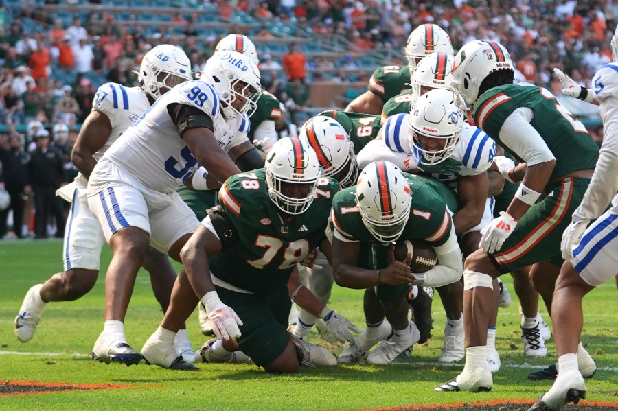 Miami quarterback Cam Ward (1) scores a two-point conversion during the second half of an NCAA college football game against Duke, Saturday, Nov. 2, 2024, in Miami Gardens, Fla. (AP Photo/Lynne Sladky)