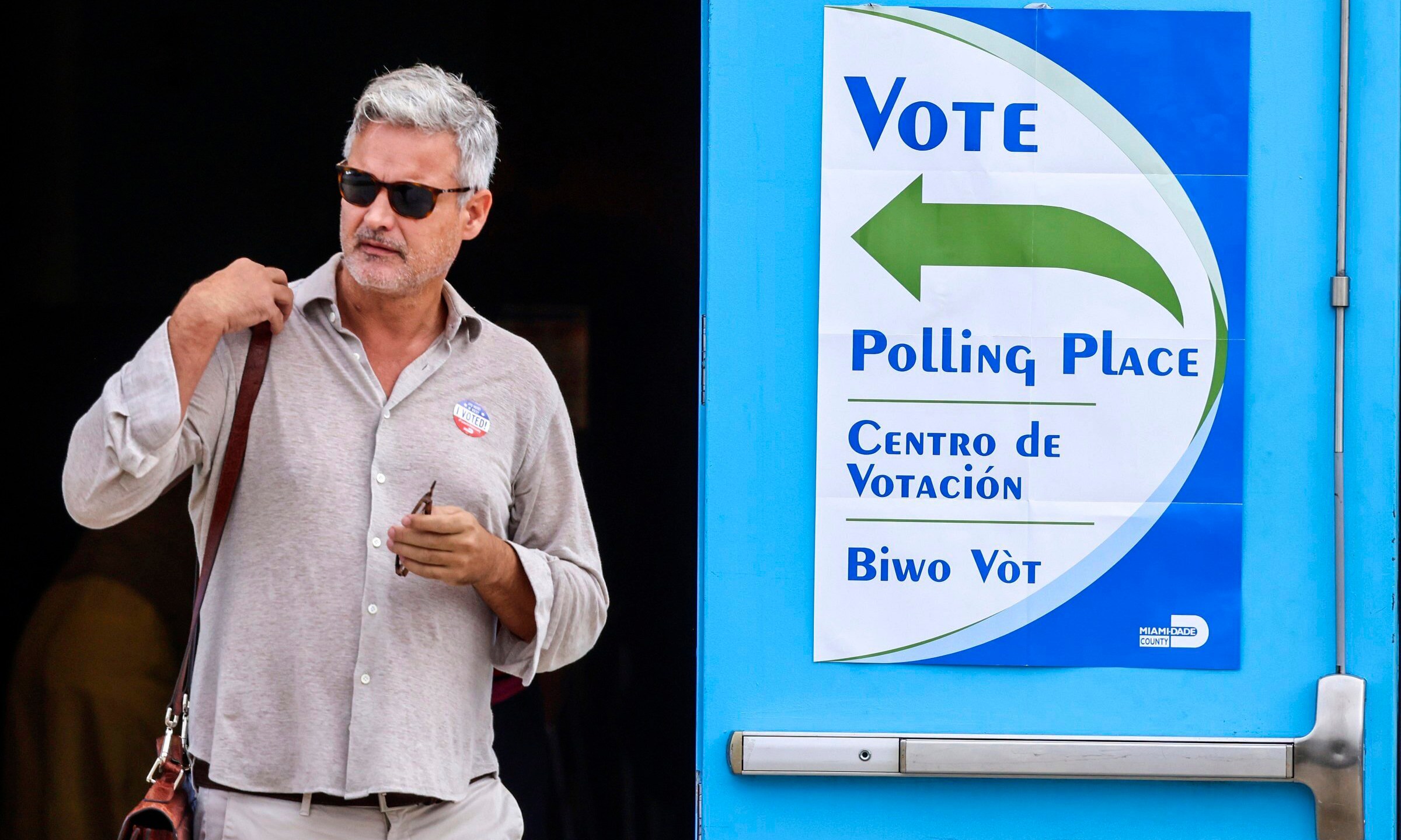 A voter exits the polling station on Election Day at the Little Haiti Cultural Complex's Caribbean Marketplace in Miami's Little Haiti neighborhood on Tuesday, Nov. 5, 2024. (Carl Juste/Miami Herald via AP)