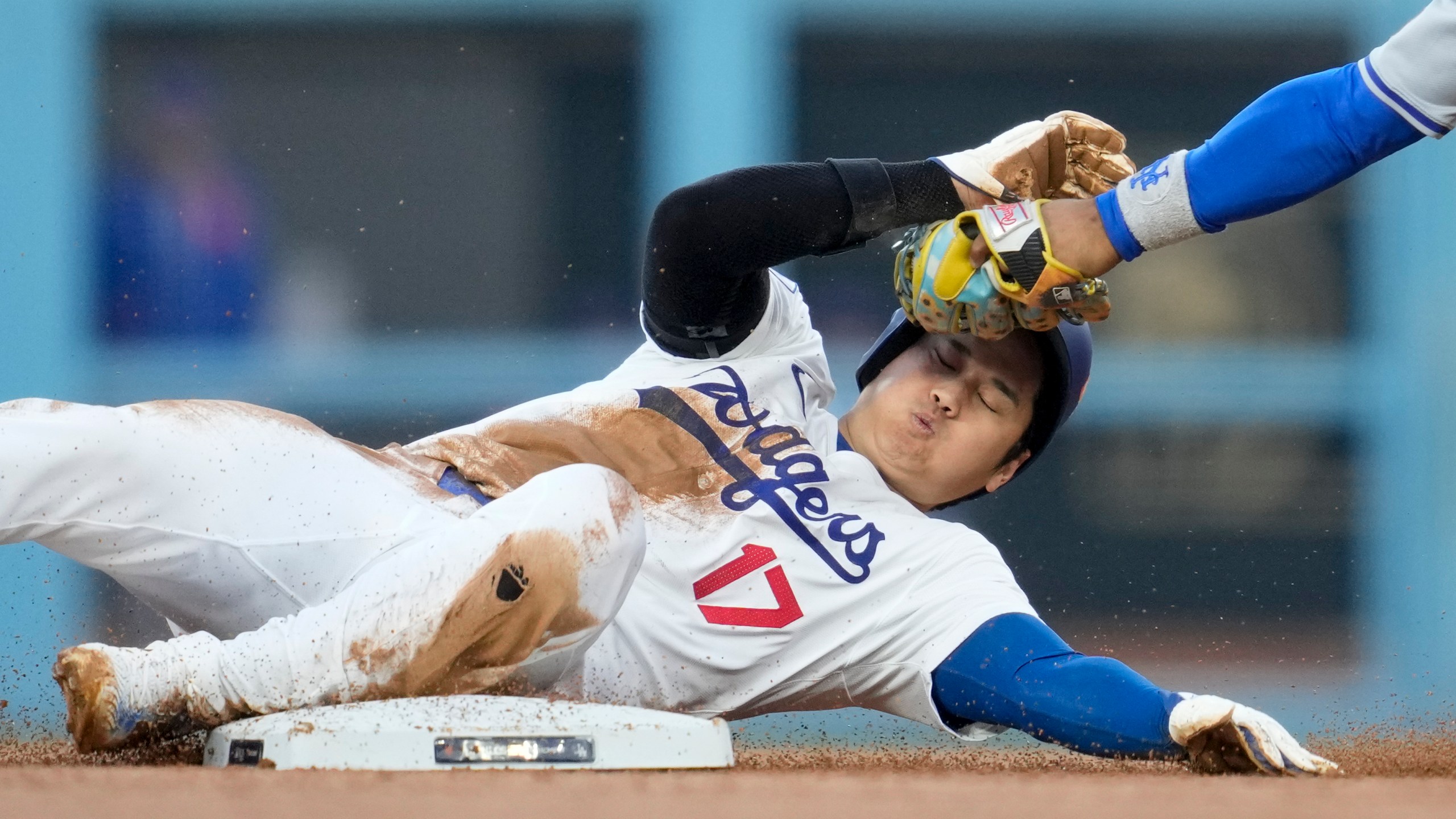 Los Angeles Dodgers' Shohei Ohtani gets caught stealing by New York Mets shortstop Francisco Lindor during the second inning in Game 1 of a baseball NL Championship Series, Sunday, Oct. 13, 2024, in Los Angeles. (AP Photo/Ashley Landis)