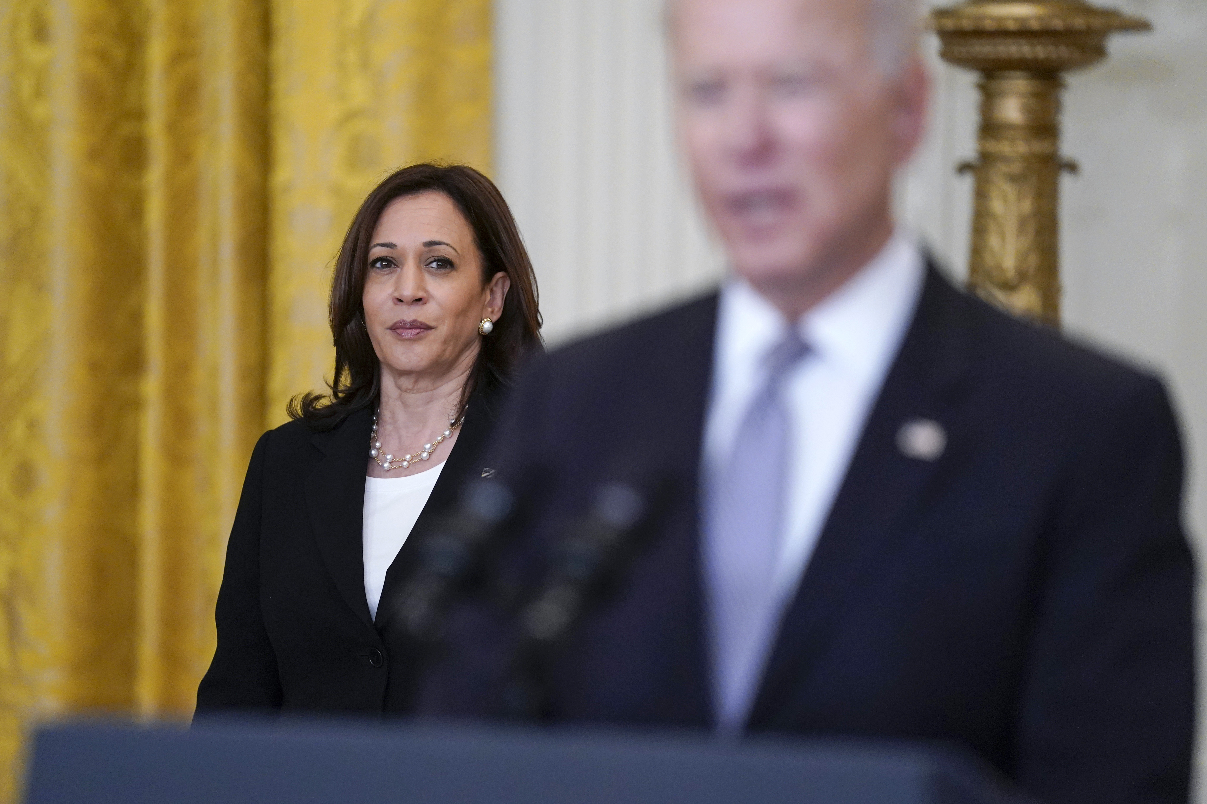 FILE - Vice President Kamala Harris listens as President Joe Biden speaks about distribution of COVID-19 vaccines, in the East Room of the White House, May 17, 2021, in Washington. (AP Photo/Evan Vucci, File)