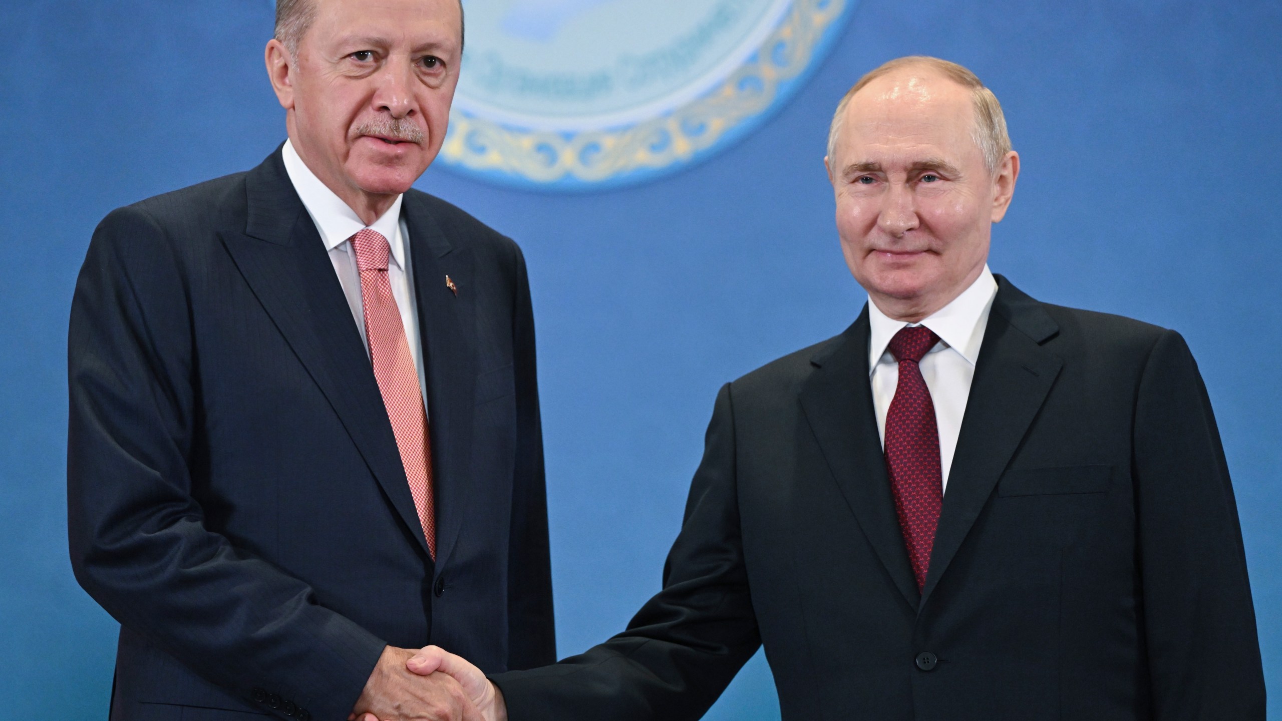 FILE - Russian President Vladimir Putin, right, and Turkey's President Recep Tayyip Erdogan shake hands as they pose for photos during a meeting on the sidelines of the Shanghai Cooperation Organization summit in Astana, Kazakhstan, on July 3, 2024. (Sergey Guneyev, Sputnik, Kremlin Pool Photo via AP, File)