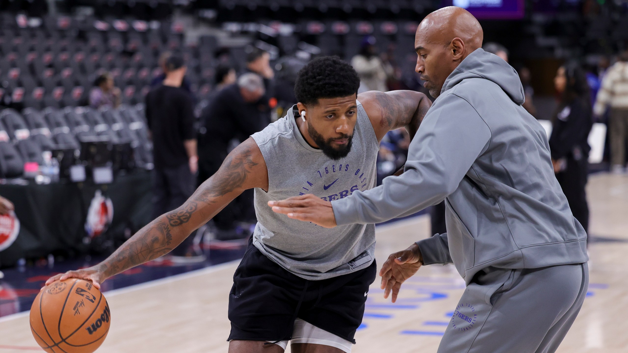 Philadelphia 76ers forward Paul George, left, warms up before an NBA basketball game against the Los Angeles Clippers, Wednesday, Nov. 6, 2024, in Inglewood, Calif. (AP Photo/Ryan Sun)