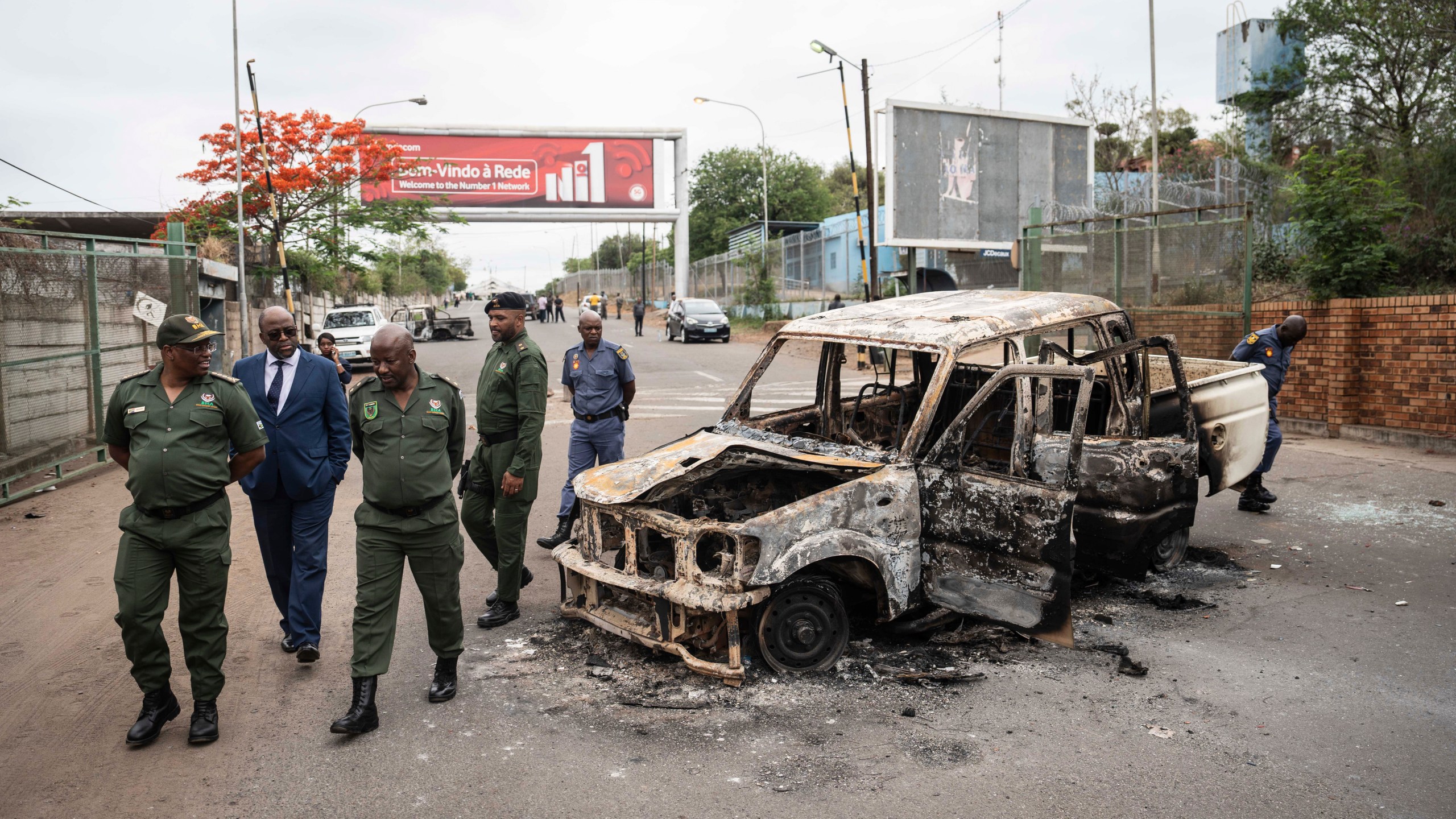 Border officials inspect a burnt-out Mozambican border patrol vehicle at the border crossing in Lebombo, South Africa, Thursday, Nov. 7, 2024. South Africa closed its border with Mozambique shortly after opening it on Thursday as post-election violence in the neighboring country escalated. (AP Photo)