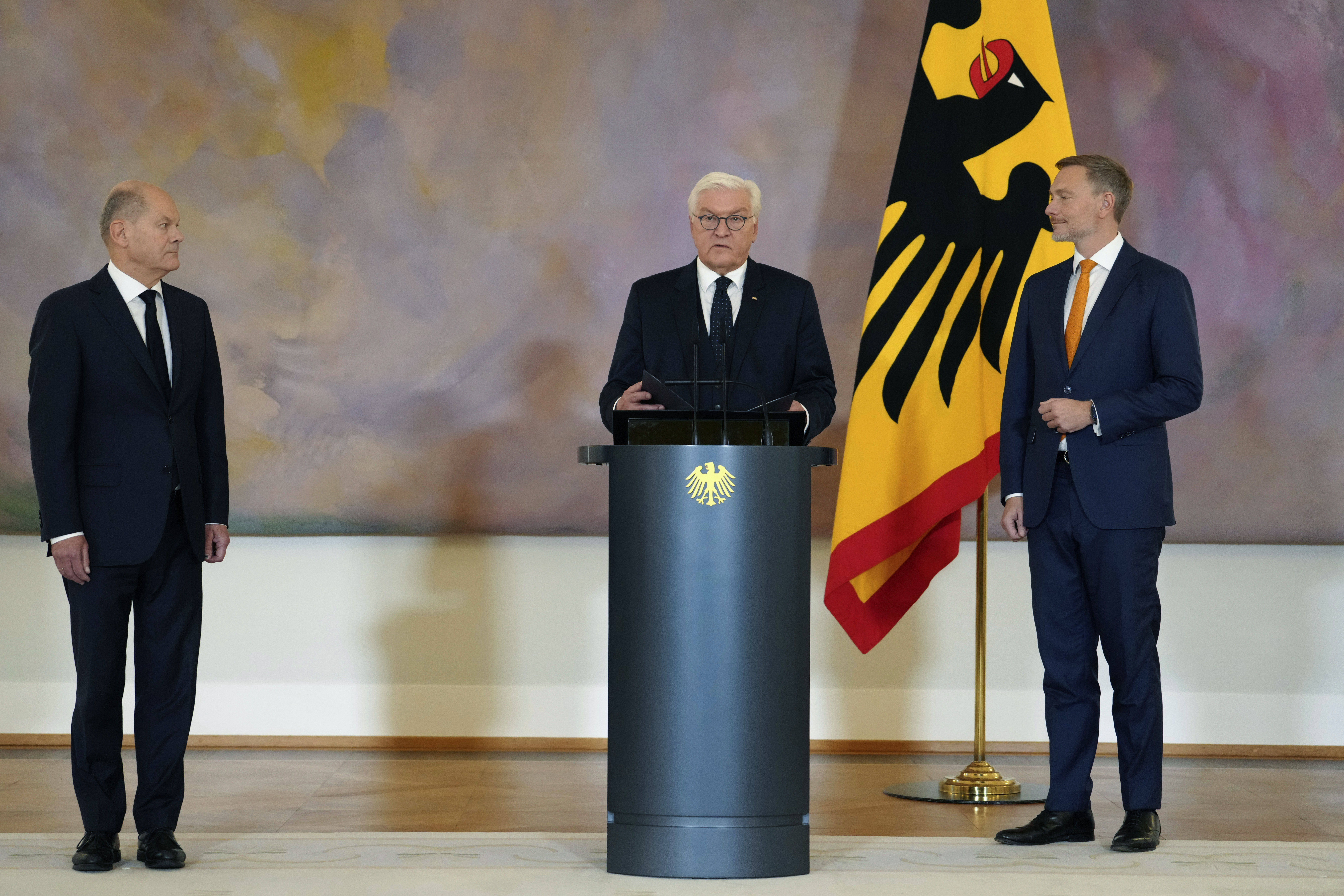 Germany's Federal President Frank-Walter Steinmeier, center, presents Christian Lindner, former Federal Minister of Finance, right, with his certificate of dismissal with German Chancellor Olaf Scholz, at left, at Bellevue Palace, in Berlin, Thursday, Nov. 7, 2024. (Kay Nietfeld/dpa via AP)