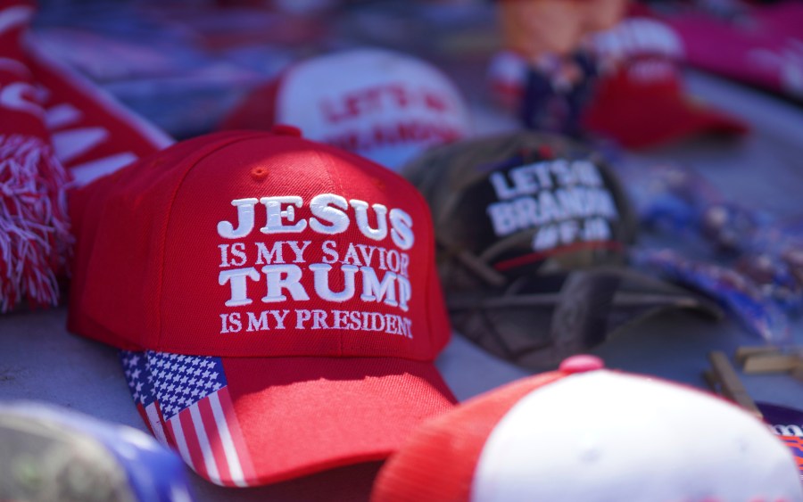 FILE - Hats reading a variety of slogans including, "Jesus is my savior, Trump is my president," are sold at a campaign rally for former President Donald Trump in Vandalia, Ohio, March 16, 2024. (AP Photo/Jessie Wardarski, File)