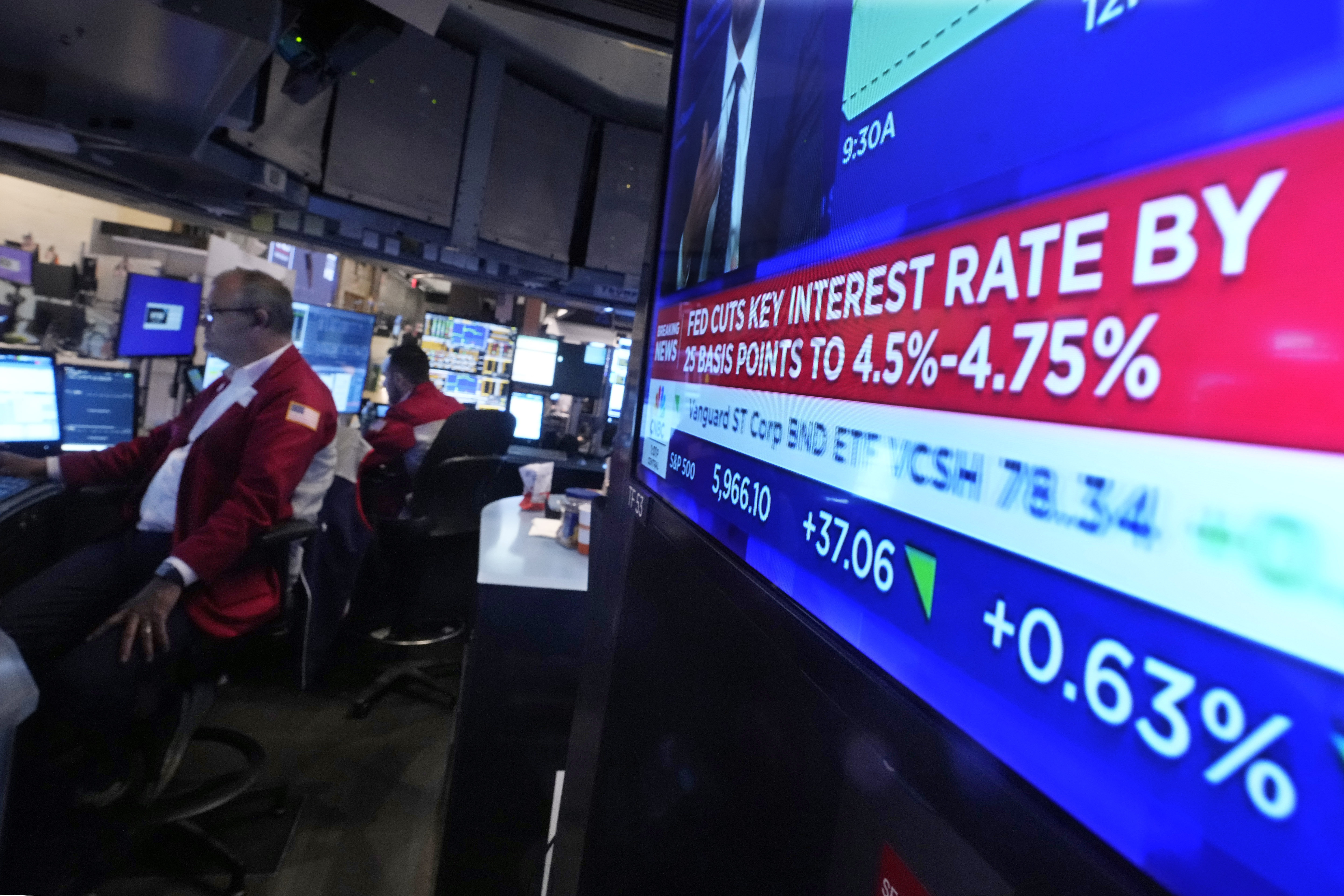 A screen at a trading post on the floor of the New York Stock Exchange displays the Federal Reserve interest rate decision, Thursday, Nov. 7, 2024. (AP Photo/Richard Drew)