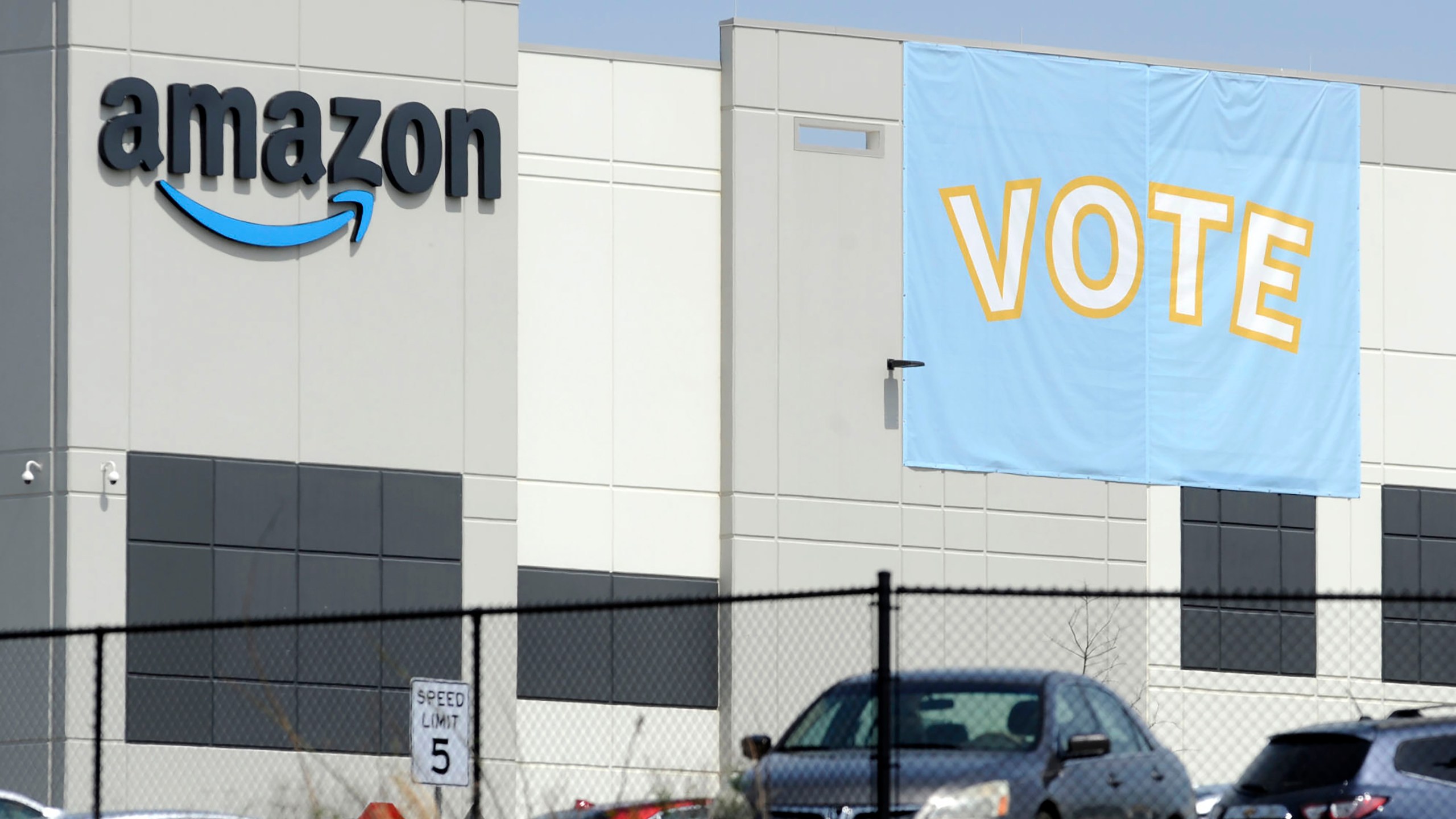 FILE - In this March 30, 2021 file photo, a banner encouraging workers to vote in labor balloting is shown at an Amazon warehouse in Bessemer, Ala. (AP Photo/Jay Reeves, File)