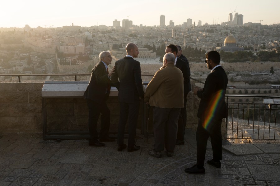 French Foreign Minister Jean-Noël Barrot, second from left, joined by by Daniel Seidemann, left, overlook the Old City from the Mount of Olives during his visit to Jerusalem, Thursday, Nov. 7, 2024. (AP Photo/Maya Alleruzzo)