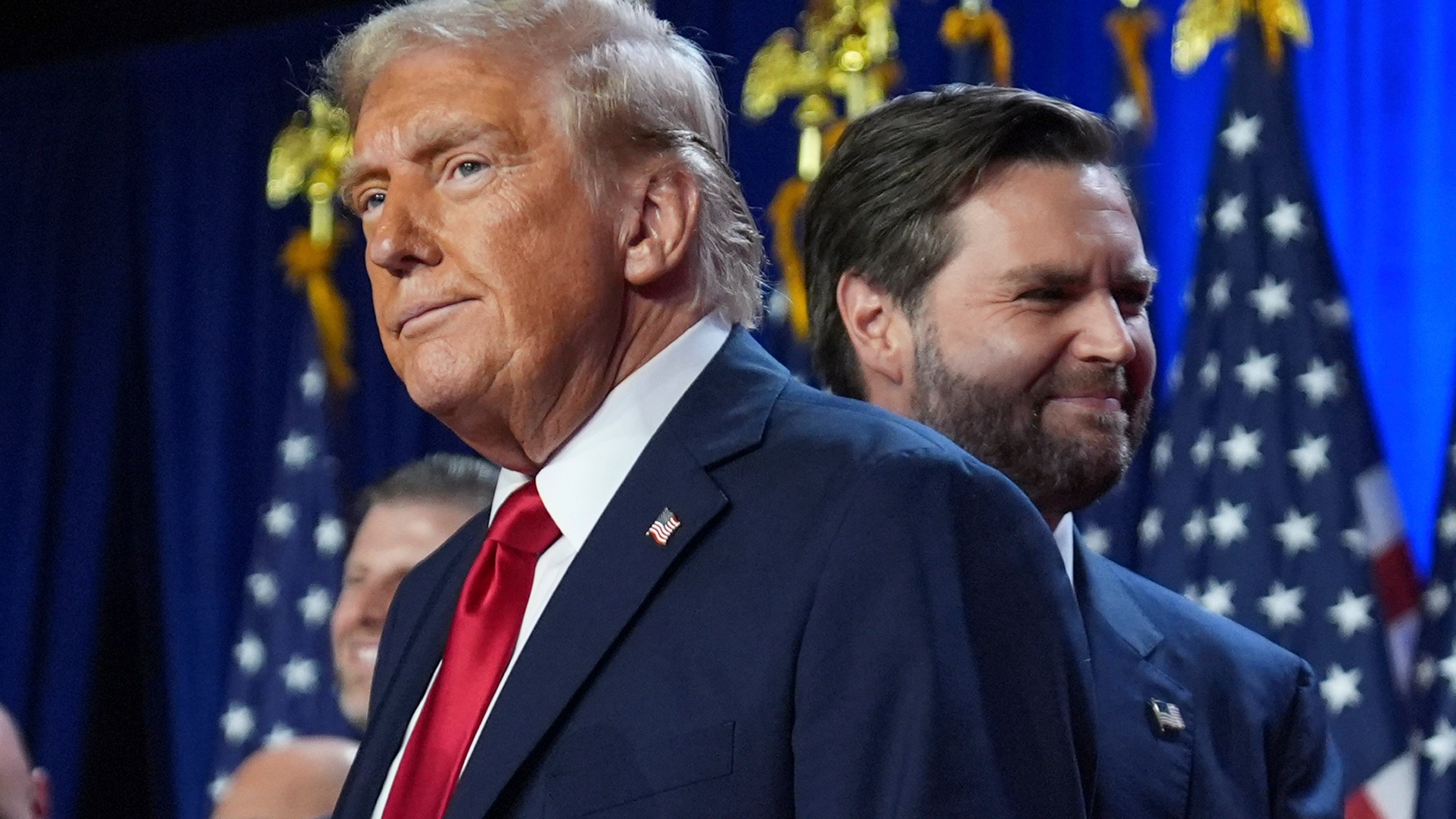 Republican presidential nominee former President Donald Trump and his running mate Sen. JD Vance, R-Ohio, stand on stage at an election night watch party at the Palm Beach Convention Center, Wednesday, Nov. 6, 2024, in West Palm Beach, Fla. (AP Photo/Evan Vucci)