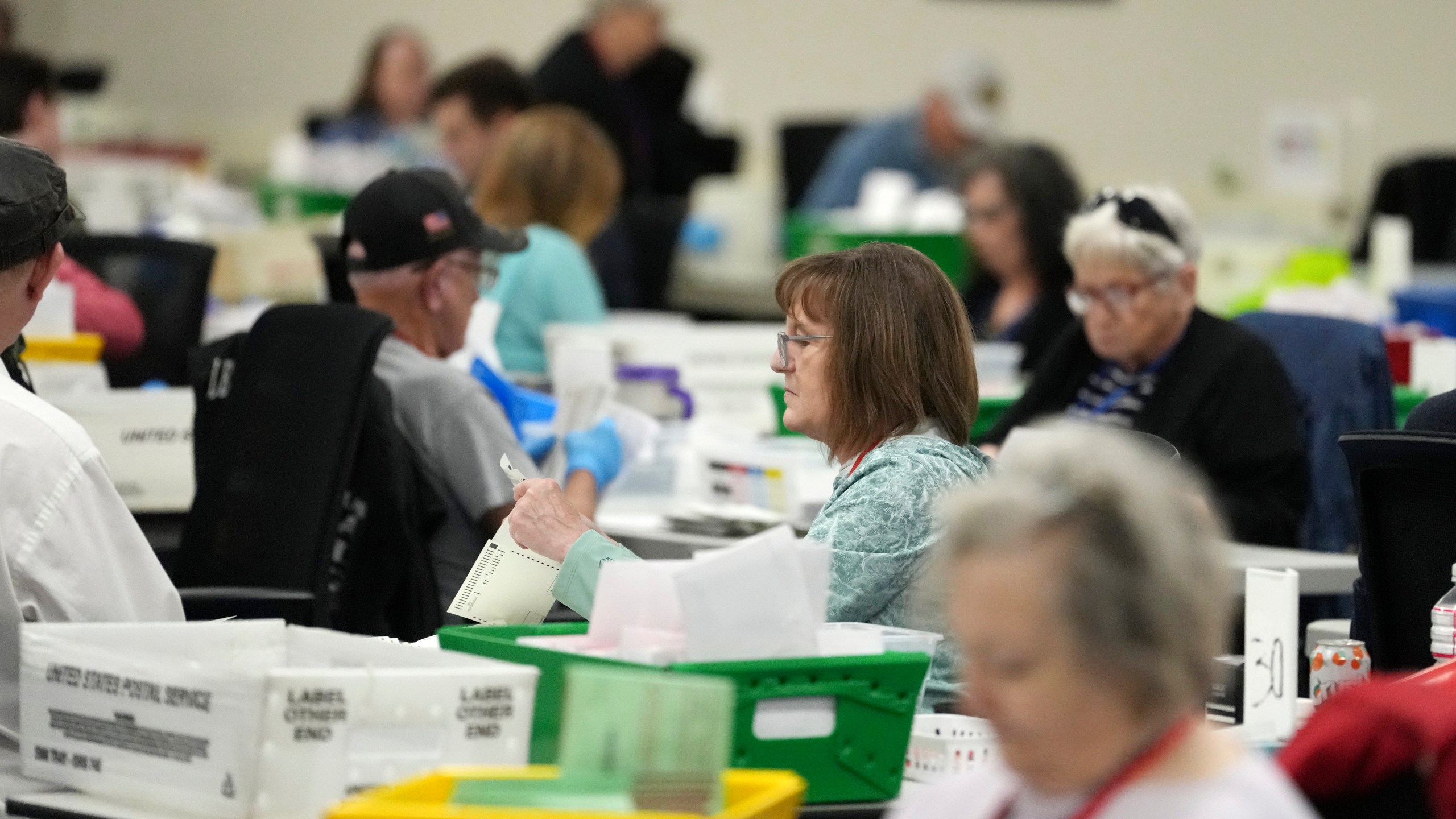 Election workers process ballots at the Maricopa County Tabulation Center Wednesday, Nov. 6, 2024, in Phoenix. (AP Photo/Ross D. Franklin)