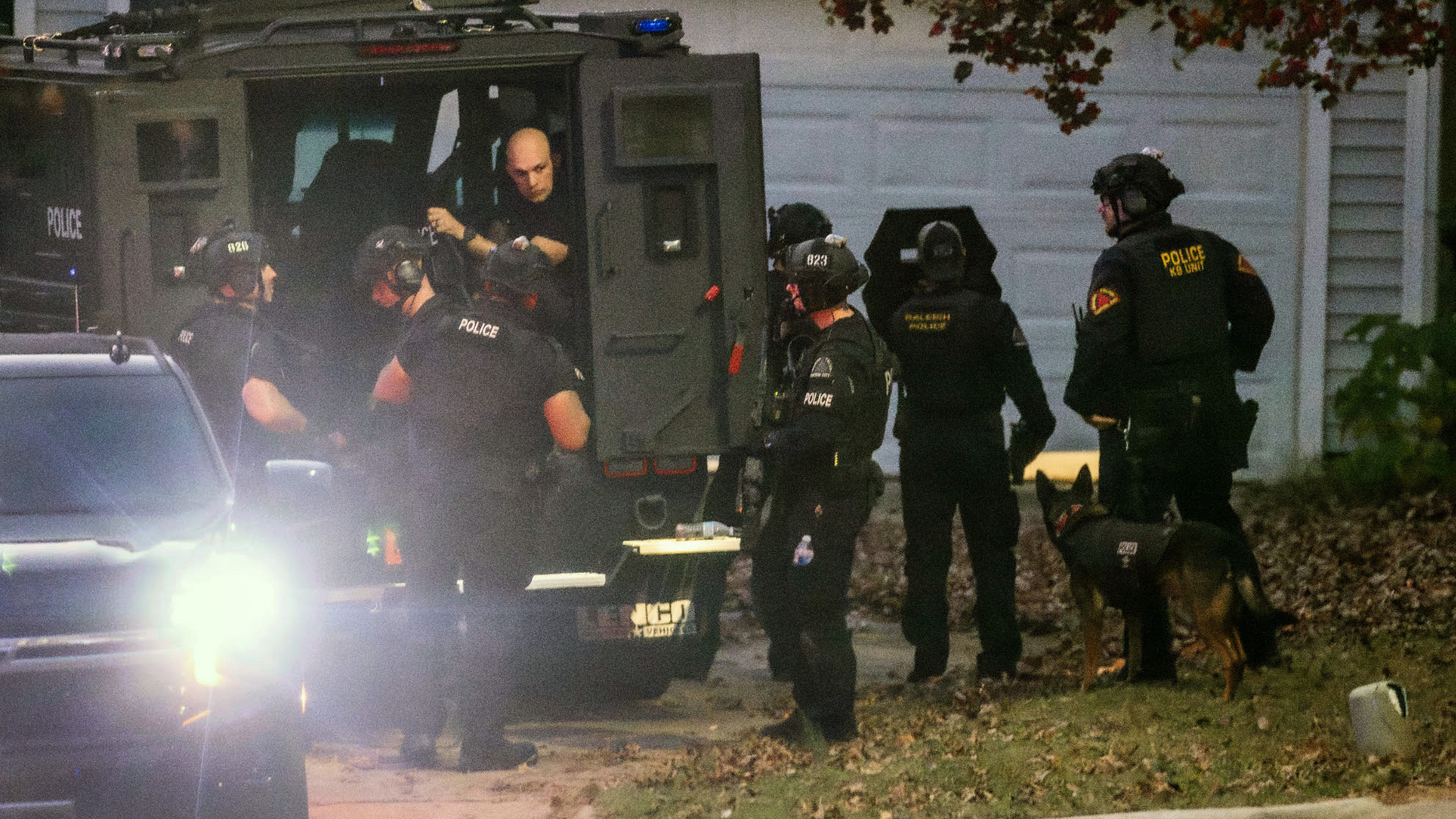 Raleigh police officers, some in tactical gear, work the scene where two people were detained Thursday afternoon, Nov. 7, 2024, on Kentford Court in Raleigh Thursday, Nov. 7, 2024, after someone repeatedly fired at cars on a busy highway near North Carolina’s capital this week, injuring one person. (Travis Long/The News & Observer via AP)