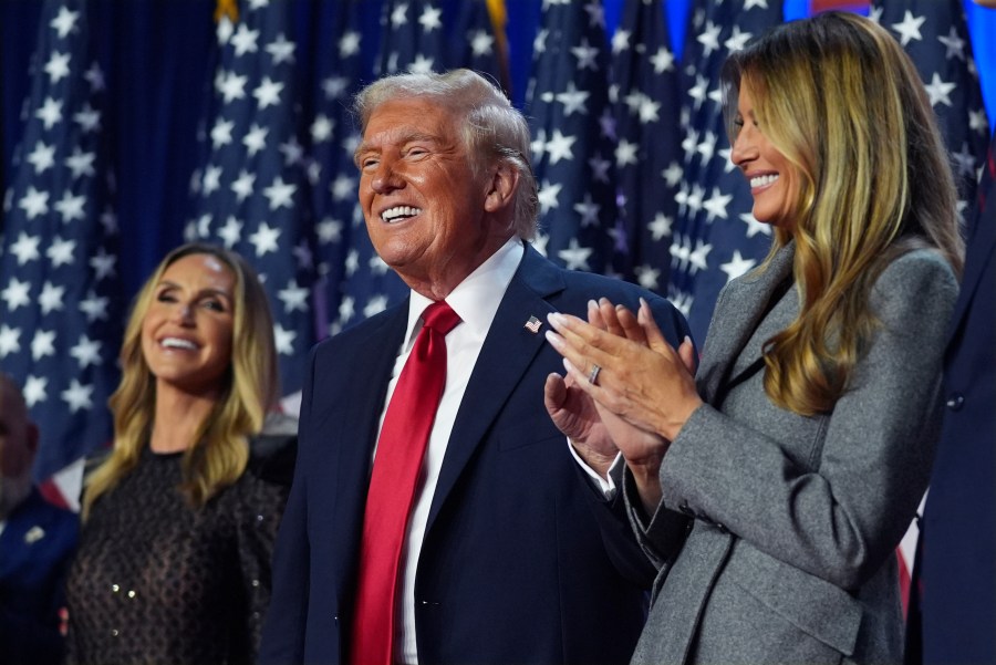 Republican presidential nominee former President Donald Trump stands on stage with former first lady Melania Trump, as Lara Trump watches, at an election night watch party at the Palm Beach Convention Center, Wednesday, Nov. 6, 2024, in West Palm Beach, Fla. (AP Photo/Evan Vucci)