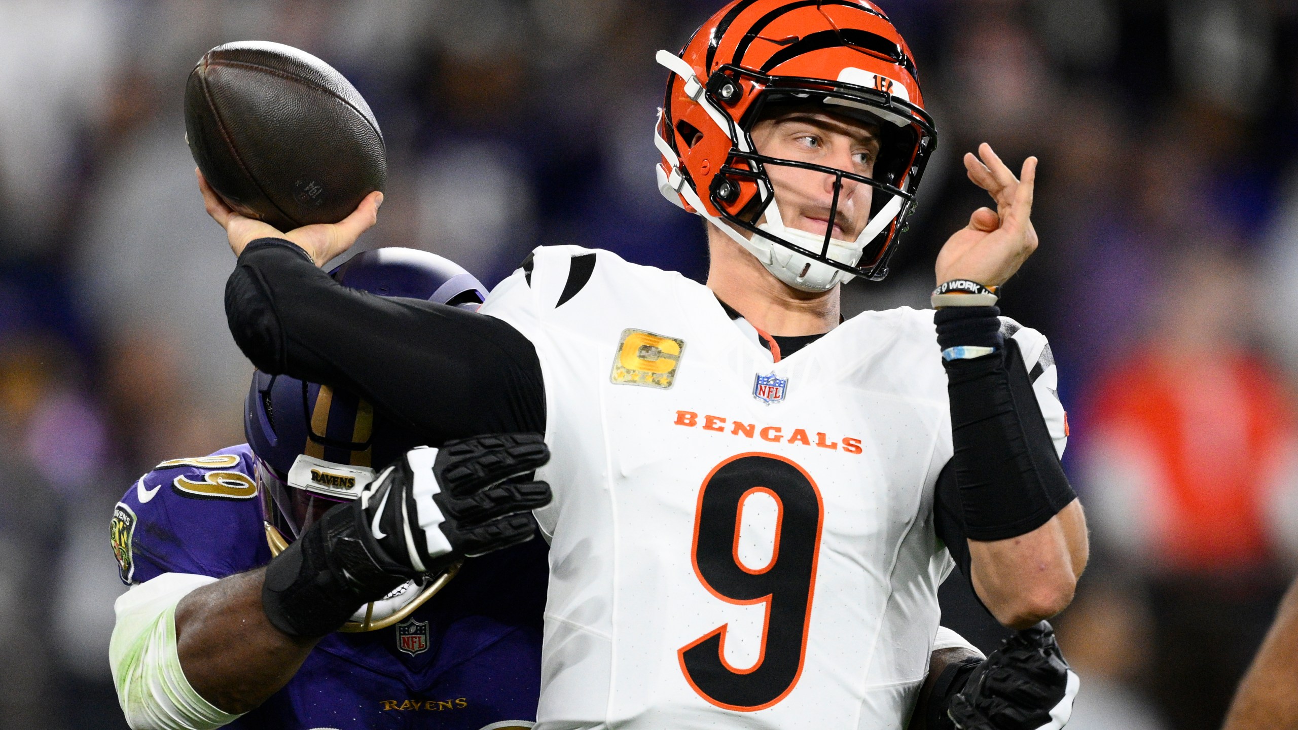 Baltimore Ravens linebacker Odafe Oweh, left, pressures Cincinnati Bengals quarterback Joe Burrow (9) as he passes the ball during the first half of an NFL football game, Thursday, Nov. 7, 2024, in Baltimore. (AP Photo/Nick Wass)