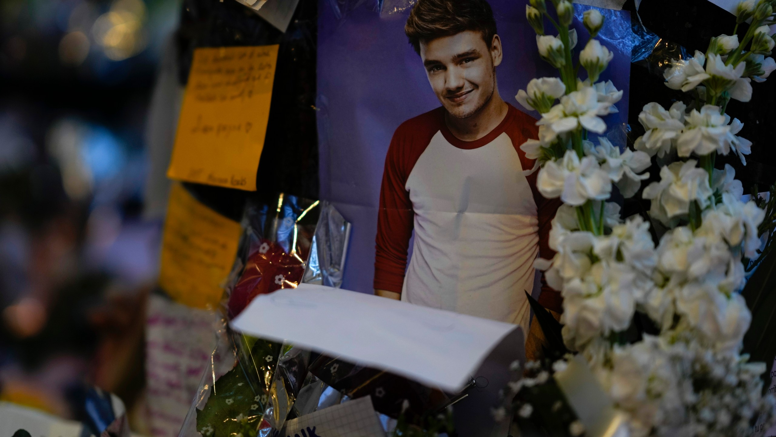 A picture of former One Direction singer Liam Payne adorns a memorial outside the hotel where he was found dead after falling from a balcony in Buenos Aires, Argentina, Thursday, Oct. 17, 2024. (AP Photo/Natacha Pisarenko)