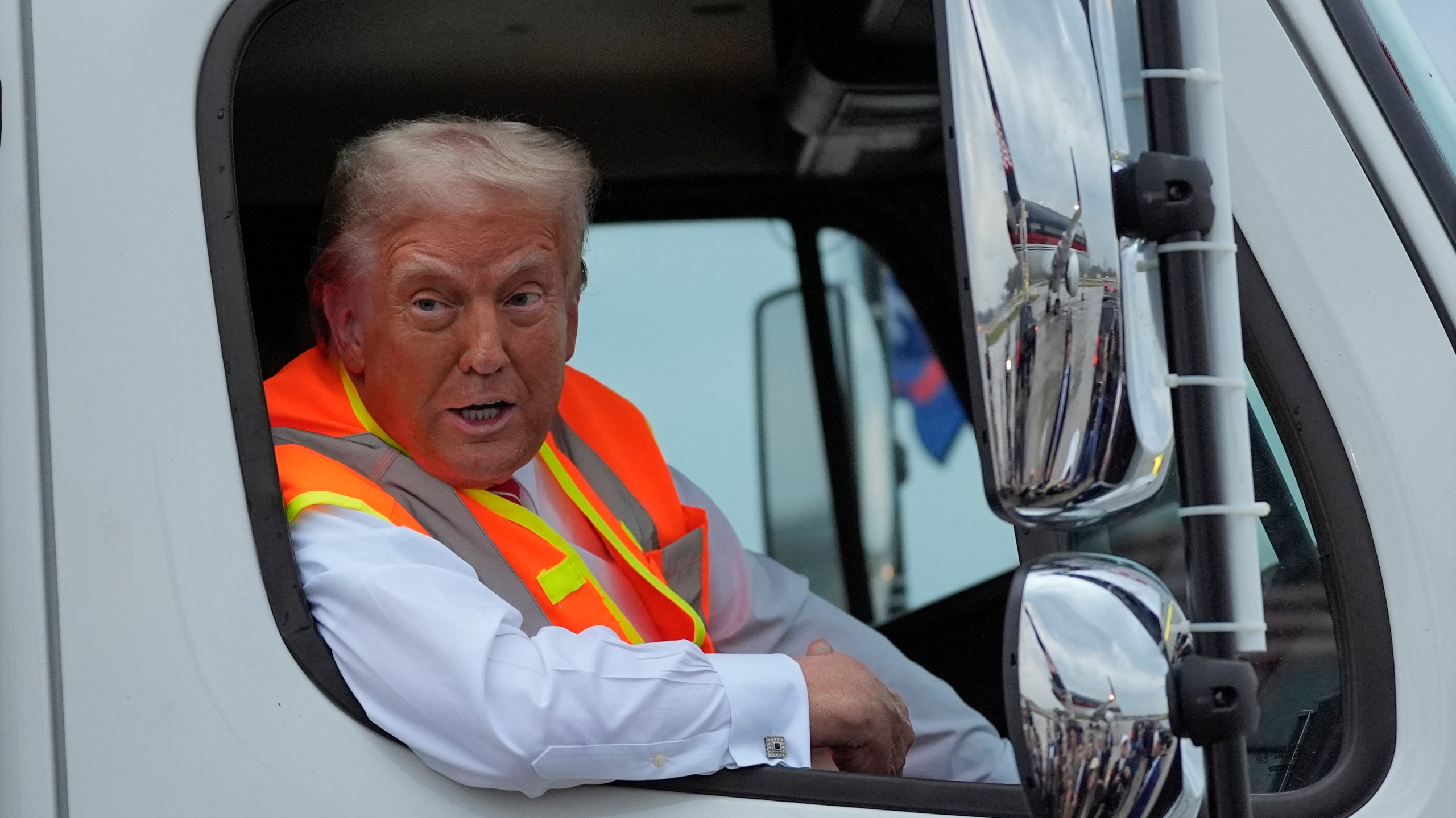 Republican presidential nominee former President Donald Trump talks to reporters as he sits in a garbage truck Wednesday, Oct. 30, 2024, in Green Bay, Wis. (AP Photo/Julia Demaree Nikhinson)