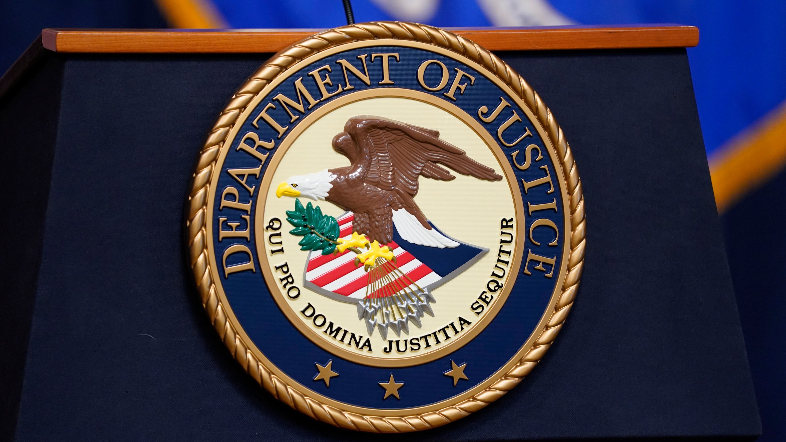 FILE - The seal for the United States Department of Justice is displayed on a podium before a news conference at the Justice Department in Washington, Thursday, April 13, 2023. (AP Photo/Evan Vucci, File)