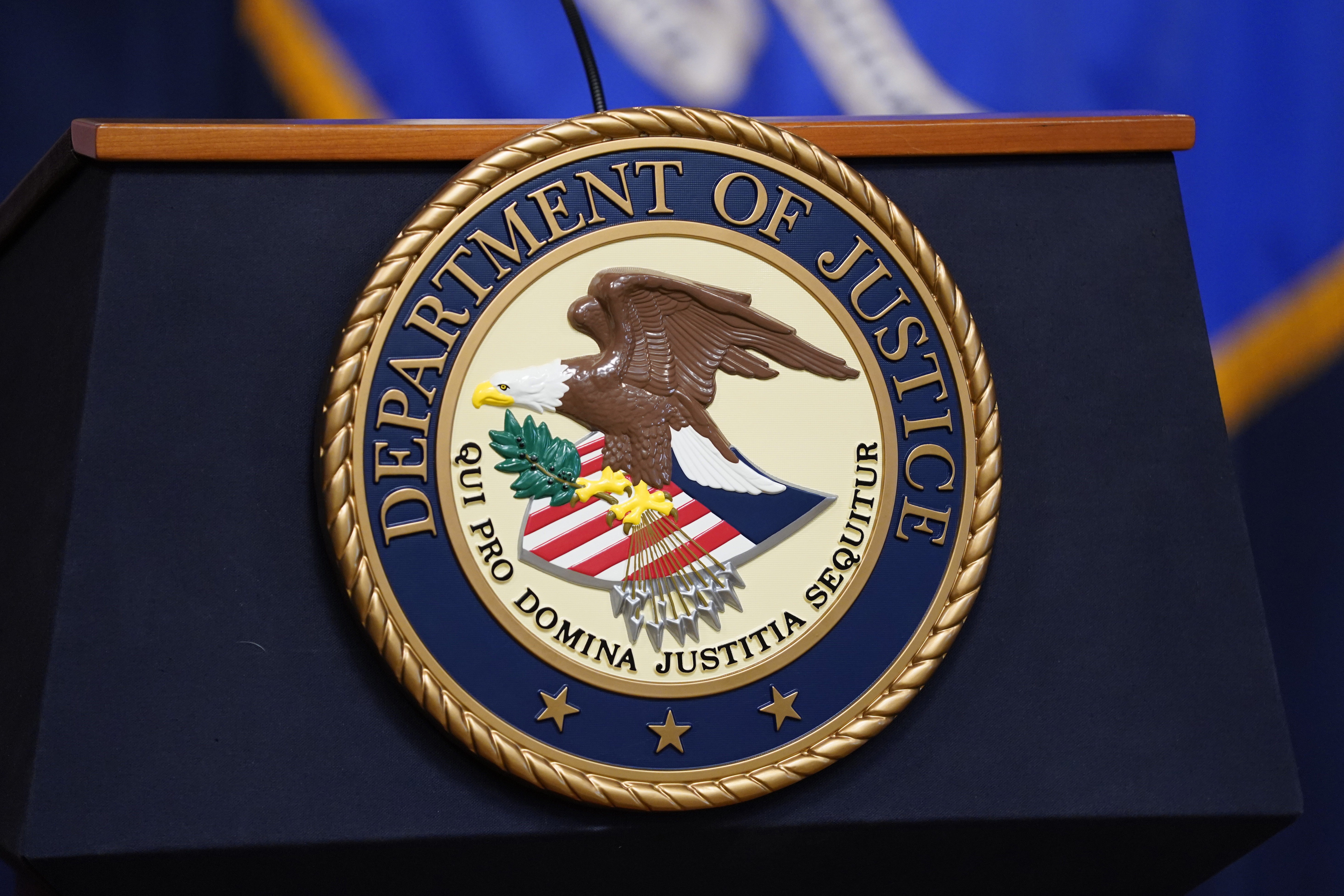 FILE - The seal for the United States Department of Justice is displayed on a podium before a news conference at the Justice Department in Washington, Thursday, April 13, 2023. (AP Photo/Evan Vucci, File)