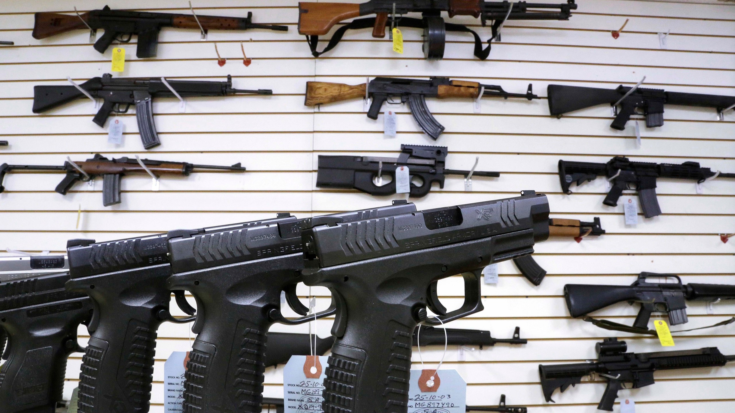 FILE - Assault style weapons and hand guns are displayed for sale at Capitol City Arms Supply on Jan. 16, 2013, in Springfield, Ill. (AP Photo/Seth Perlman, File)