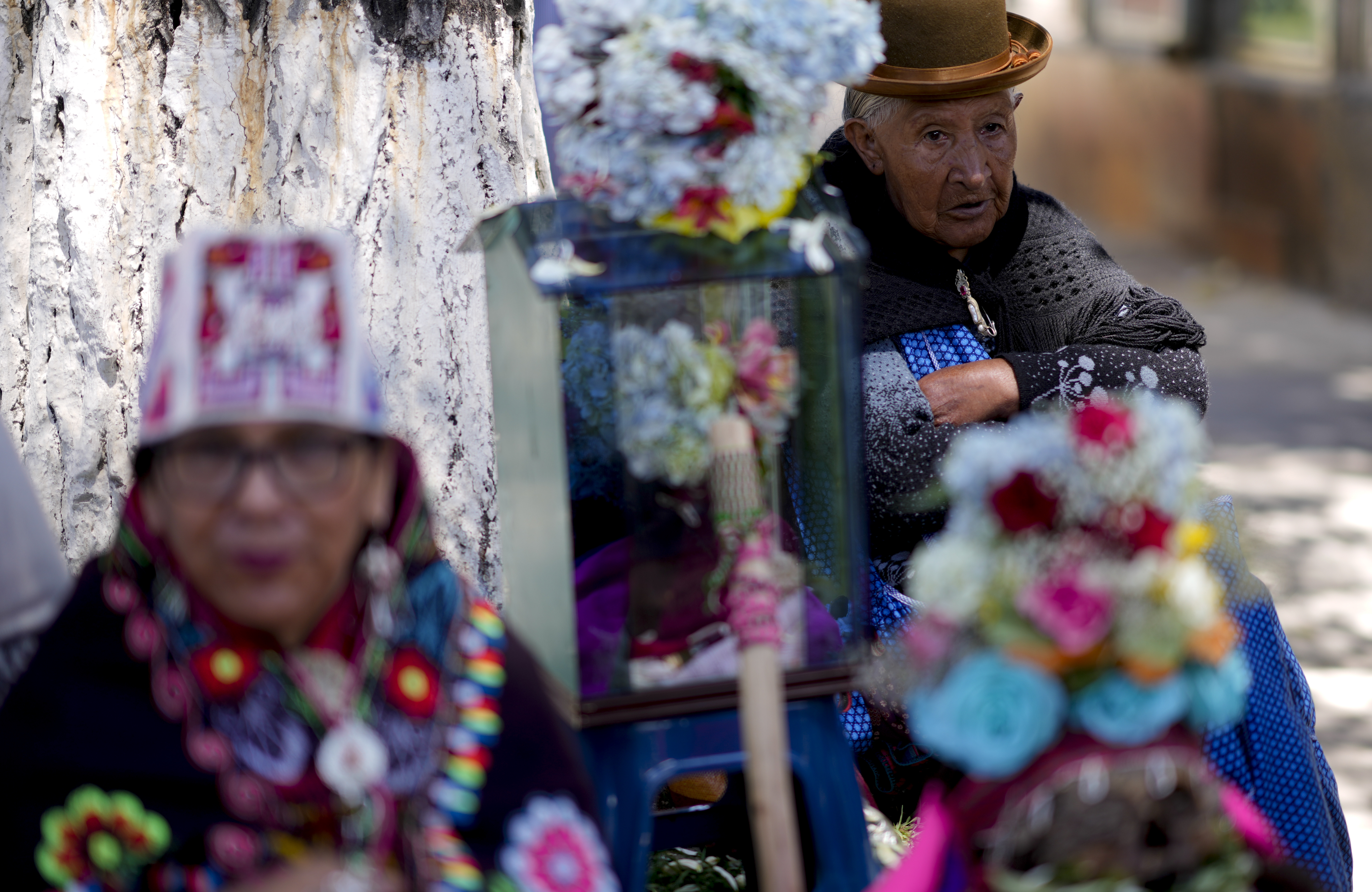 Women stand next to decorated human skulls at the General Cemetery as part of the annual "Ñatitas" festival, a tradition marking the end of the Catholic holiday of All Saints in La Paz, Bolivia, Friday, Nov. 8, 2024. (AP Photo/Juan Karita)