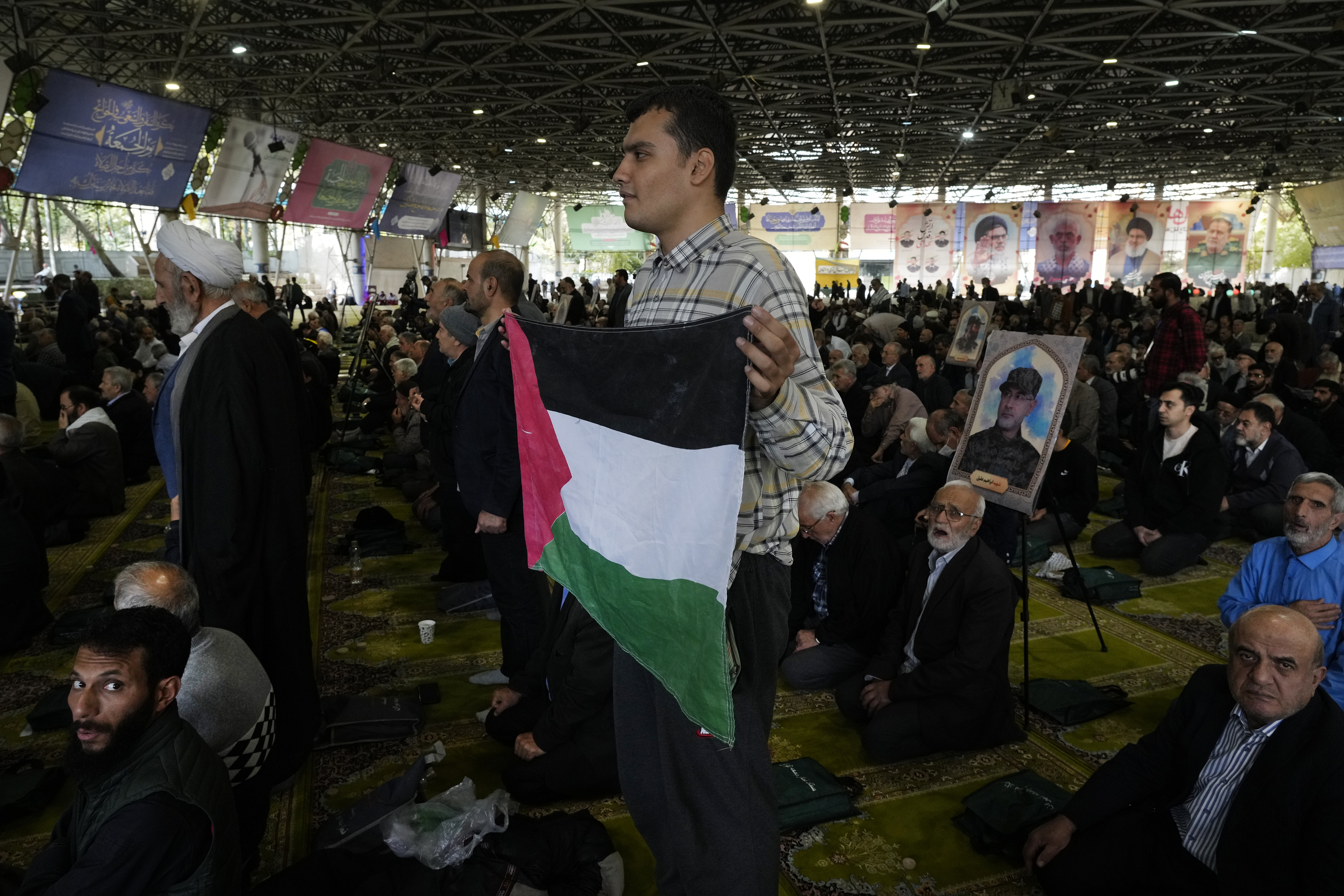 An Iranian worshipper holds a Palestinian flag during Friday prayer ceremony at the Tehran University campus, in Tehran, Iran, Friday, Nov. 8, 2024. (AP Photo/Vahid Salemi)