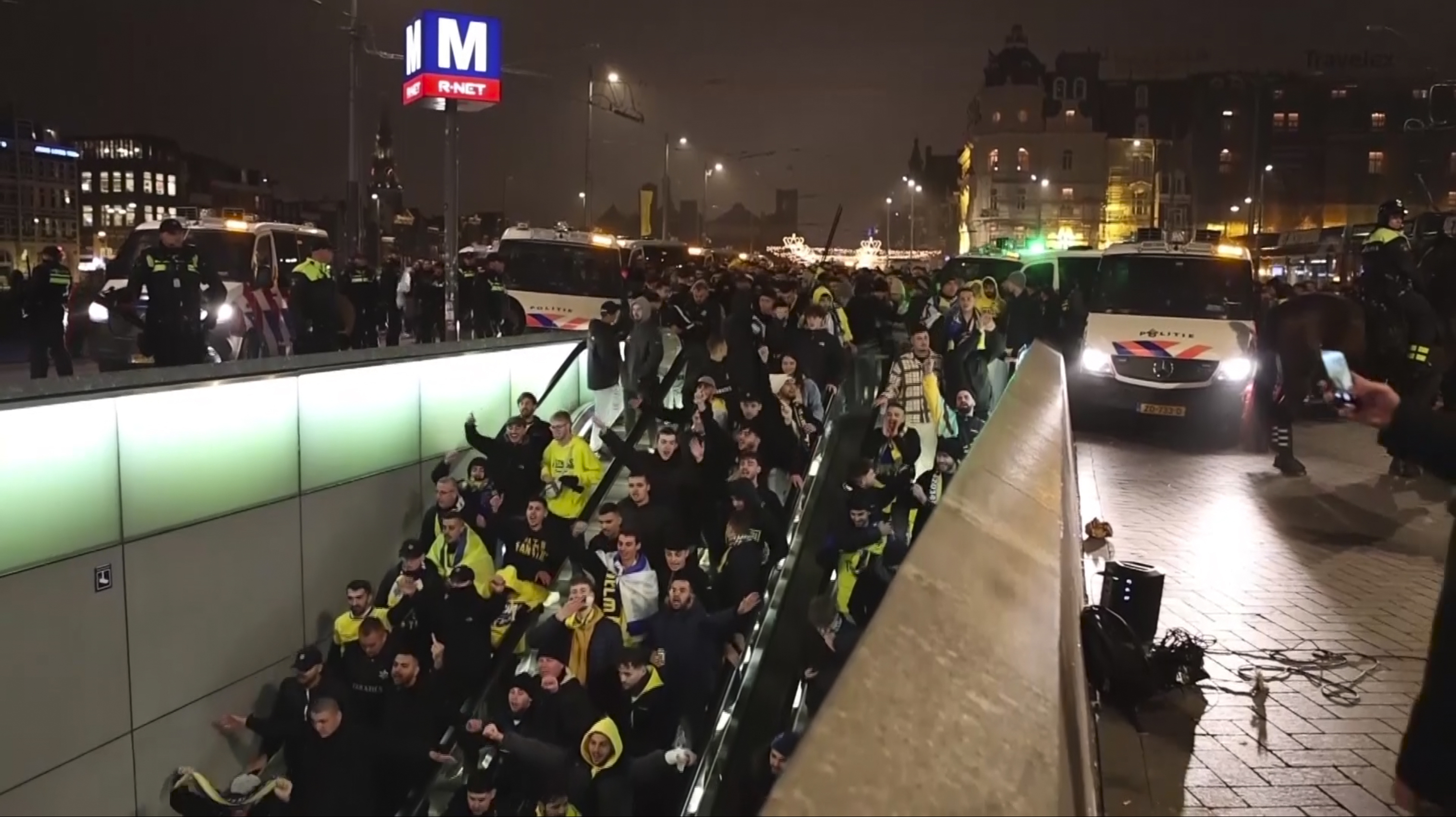 In this image taken from video, police escort Maccabi Tel Aviv supporters to the metro, after pro-Palestinian supporters marched near the soccer stadium, in Amsterdam, the Netherlands, Thursday, Nov. 7, 2024. (AP Photo InterVision)