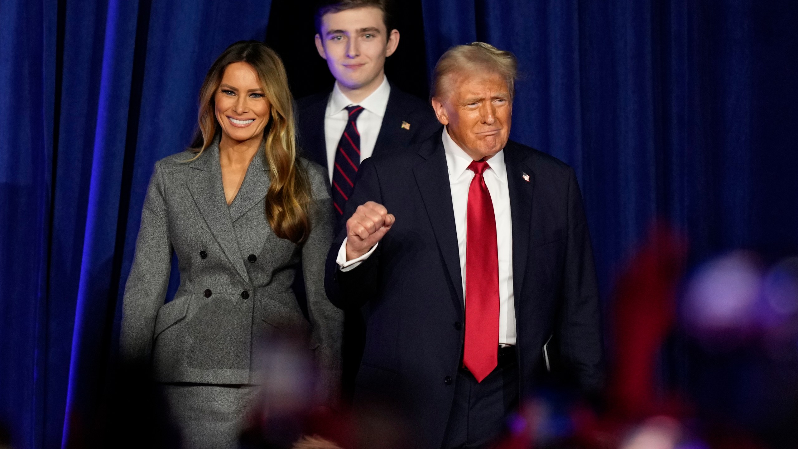 Republican presidential nominee former President Donald Trump, joined by Melania Trump, left, and Barron Trump, arrives to speak at an election night watch party, Wednesday, Nov. 6, 2024, in West Palm Beach, Fla. (AP Photo/Alex Brandon)