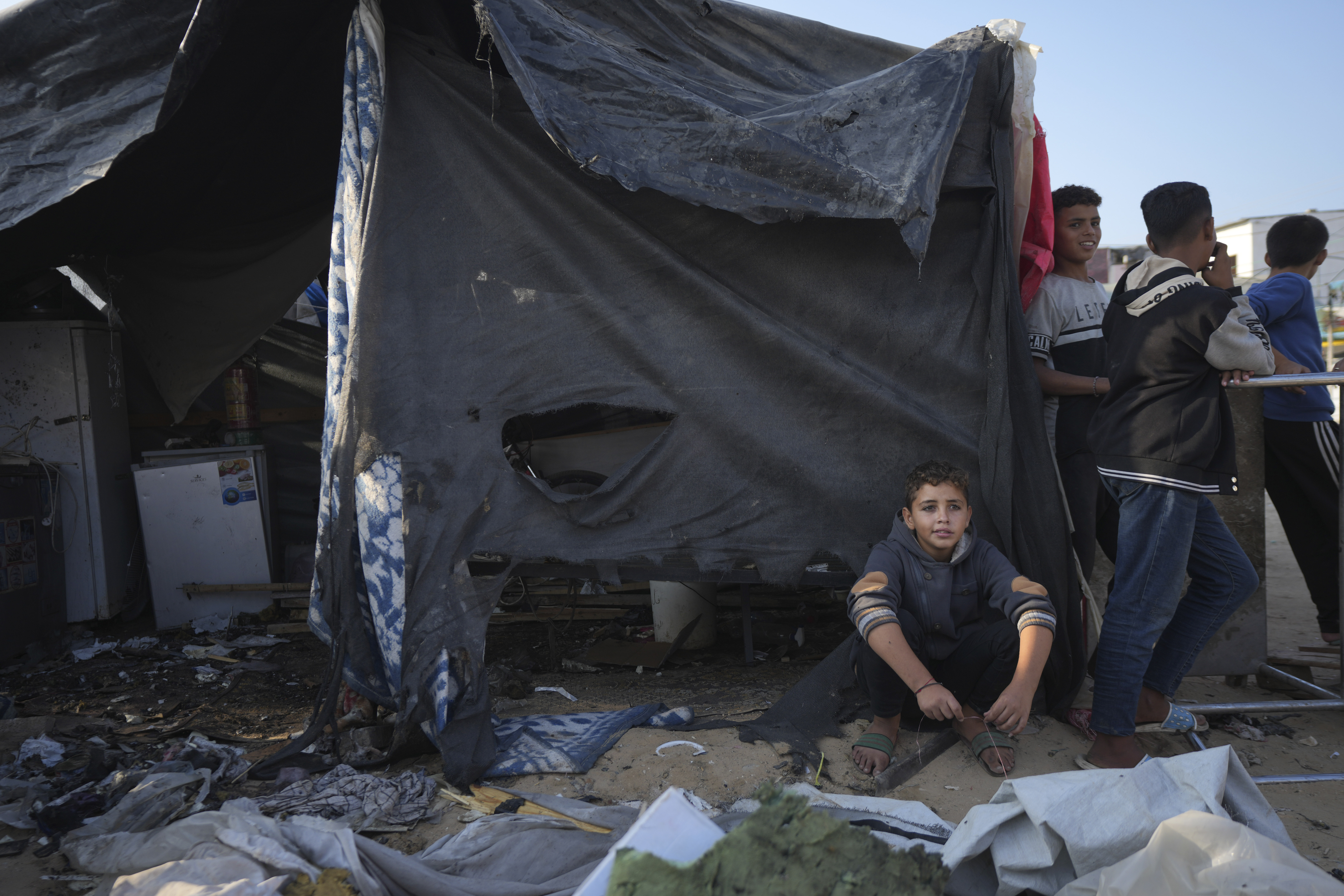 Palestinians gather at the site of an Israeli strike in the courtyard of the Al-Aqsa Hospital where displaced people live in tents, in Deir al-Balah, Gaza Strip, Saturday, Nov. 9, 2024. (AP Photo/Abdel Kareem Hana)