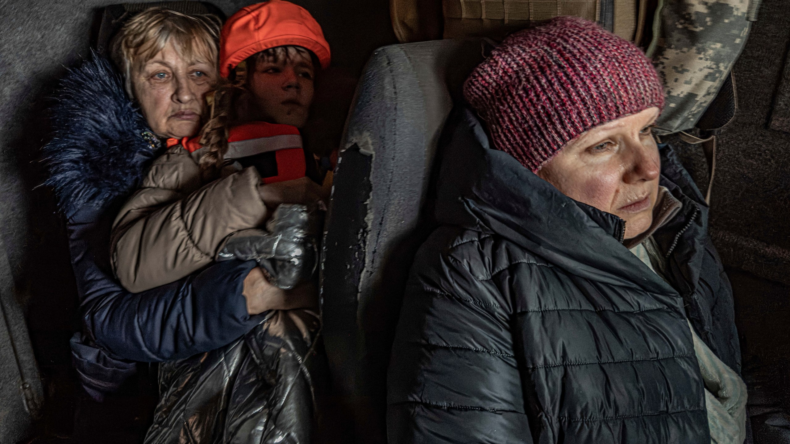 Katia, 11, with her grandmother and mother sit in an armoured minivan during en evacuation by the "White Angels" police unit in Kurakhove, Donetsk region, Ukraine, on Nov. 4, 2024. (AP Photo/Anton Shtuka)