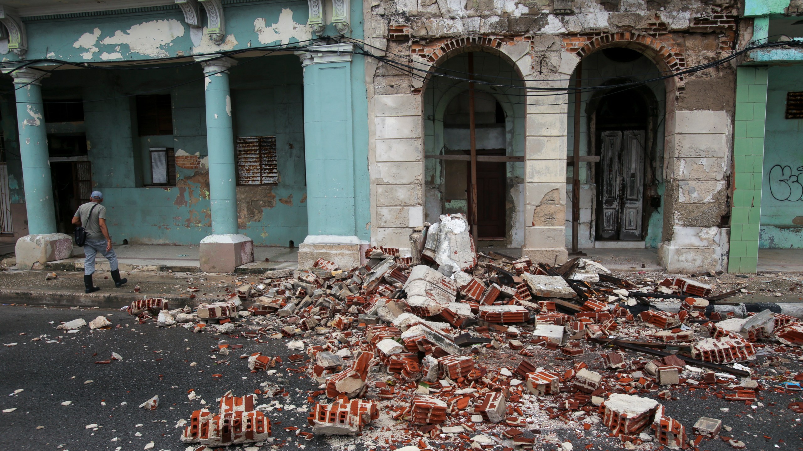 Debris from a building damaged by the passage of Hurricane Rafael covers the street in Havana, Cuba, Thursday, Nov. 7, 2024. (AP Photo/Ariel Ley)