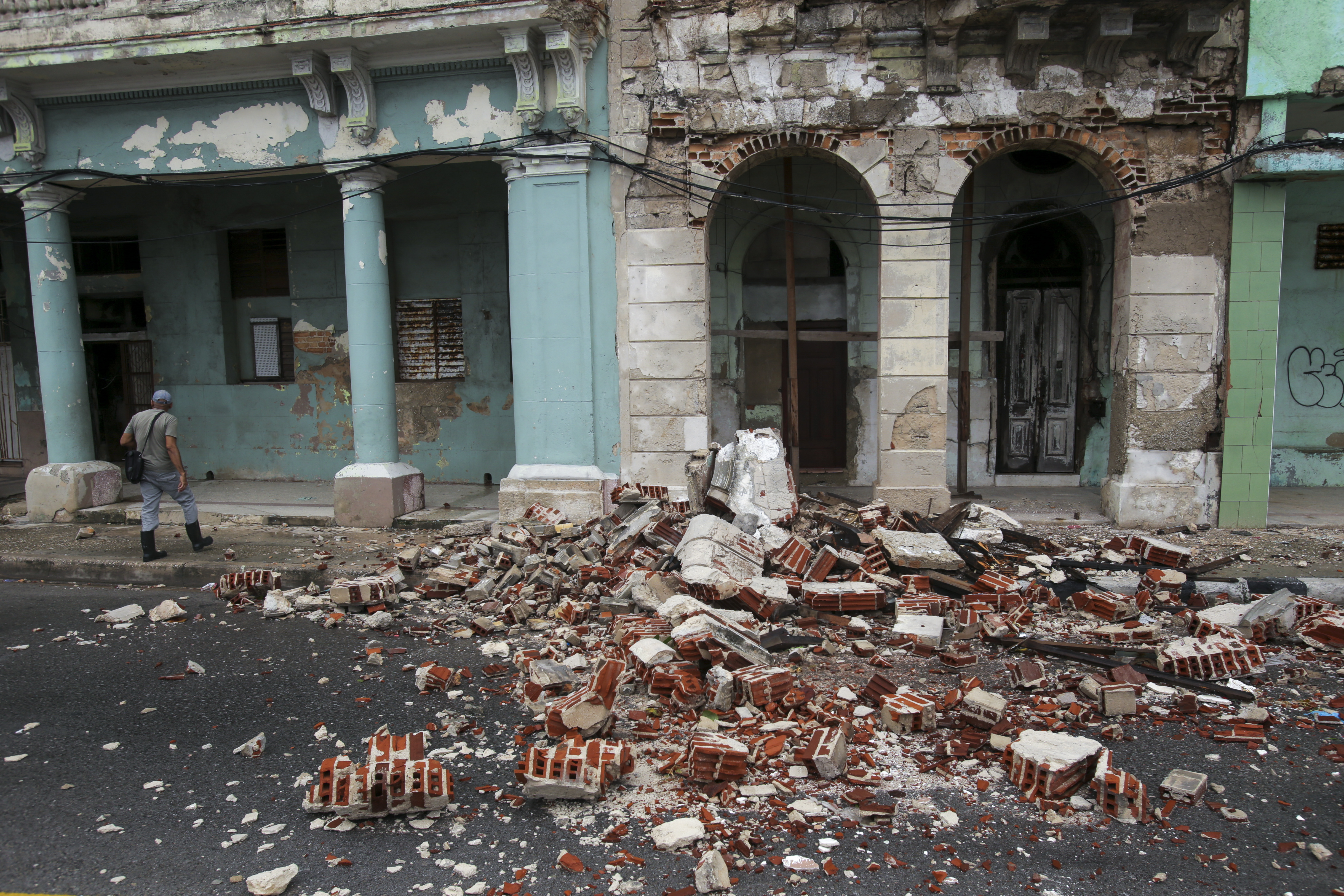 Debris from a building damaged by the passage of Hurricane Rafael covers the street in Havana, Cuba, Thursday, Nov. 7, 2024. (AP Photo/Ariel Ley)