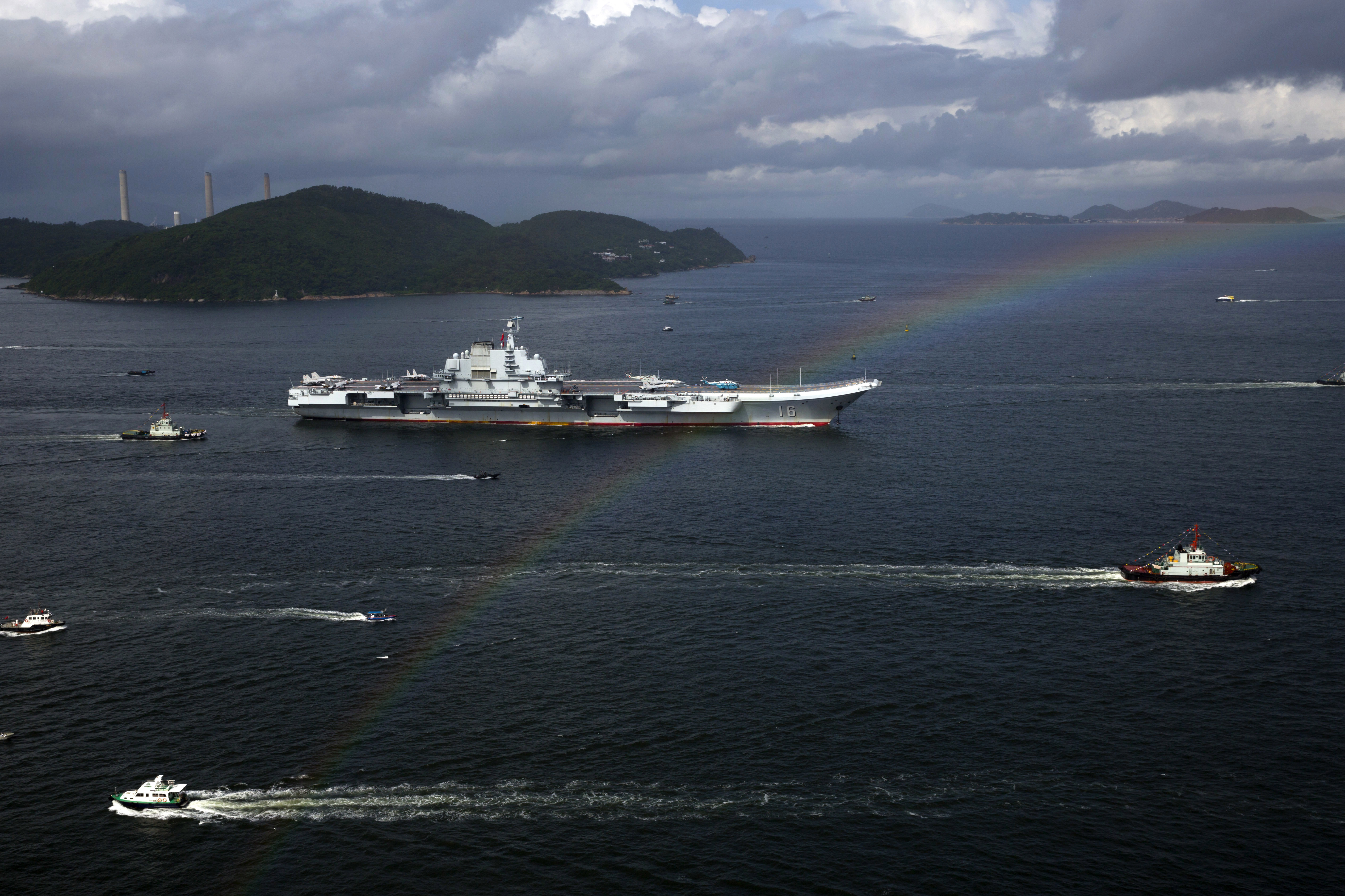 FILE- The Liaoning, China's first conventionally powered aircraft carrier, sails into Hong Kong for port call, on July 7, 2017, to celebrate the 20th anniversary of the People's Liberation Army (PLA) garrison's presence in the semi-autonomous Chinese city and former British colony. (AP Photo/Kin Cheung, File)