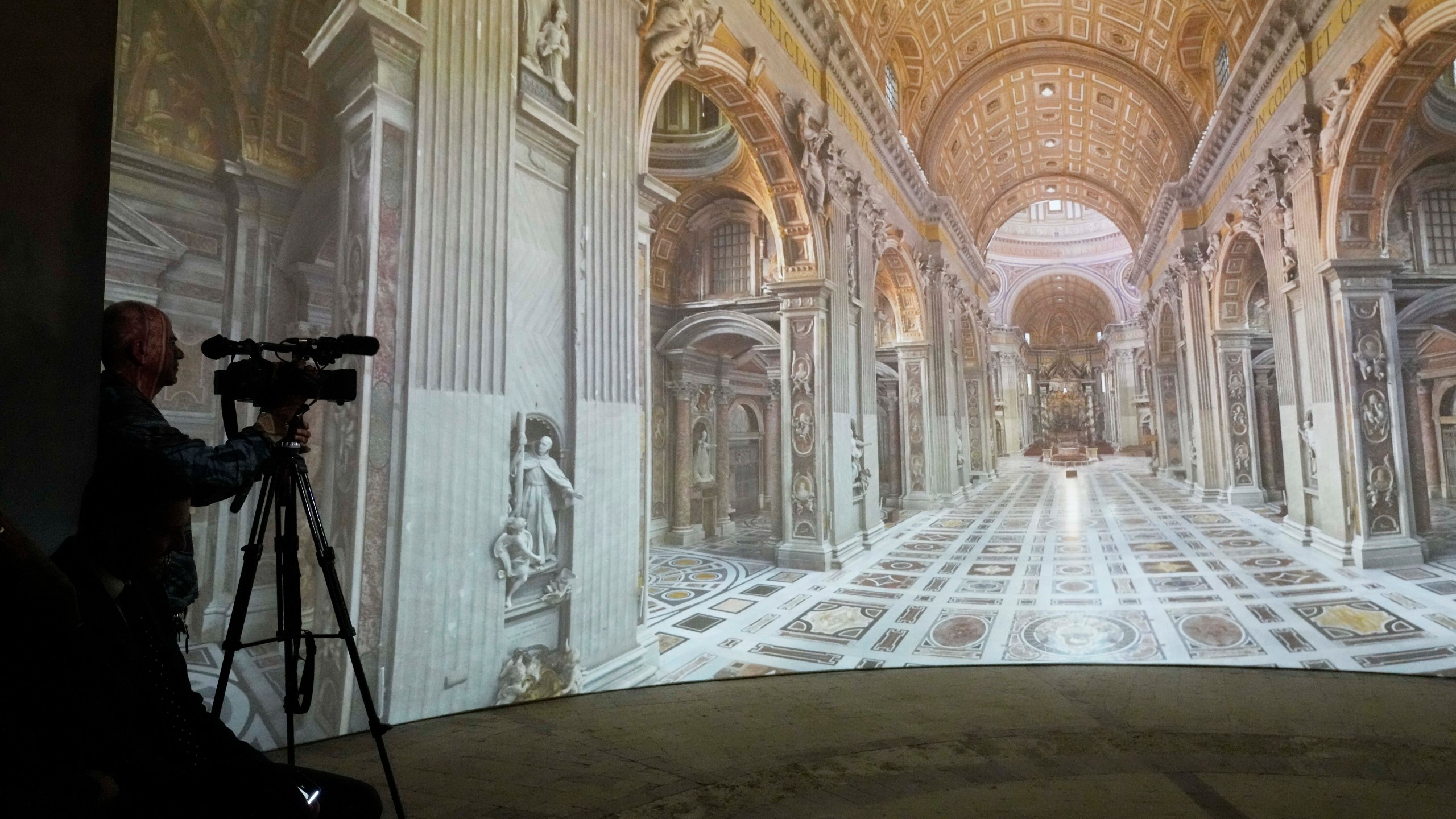 Images of St. Peter's Basilca are projected on a screen during the preview to the press of the exhibition 'Petros eni', which is part of the project "St. Peter's Basilica: AI-Enhanced Experience" at the Vatican, Saturday, Nov. 9, 2024. (AP Photo/Gregorio Borgia)