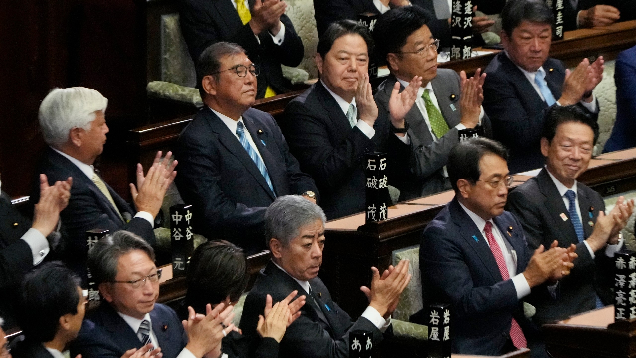 Lawmakers applaud as Japanese Prime Minister Shigeru Ishiba, second left on top, was elected for a new prime minister at a special parliamentary session of the lower house Monday, Nov. 11, 2024, in Tokyo. (AP Photo/Eugene Hoshiko)