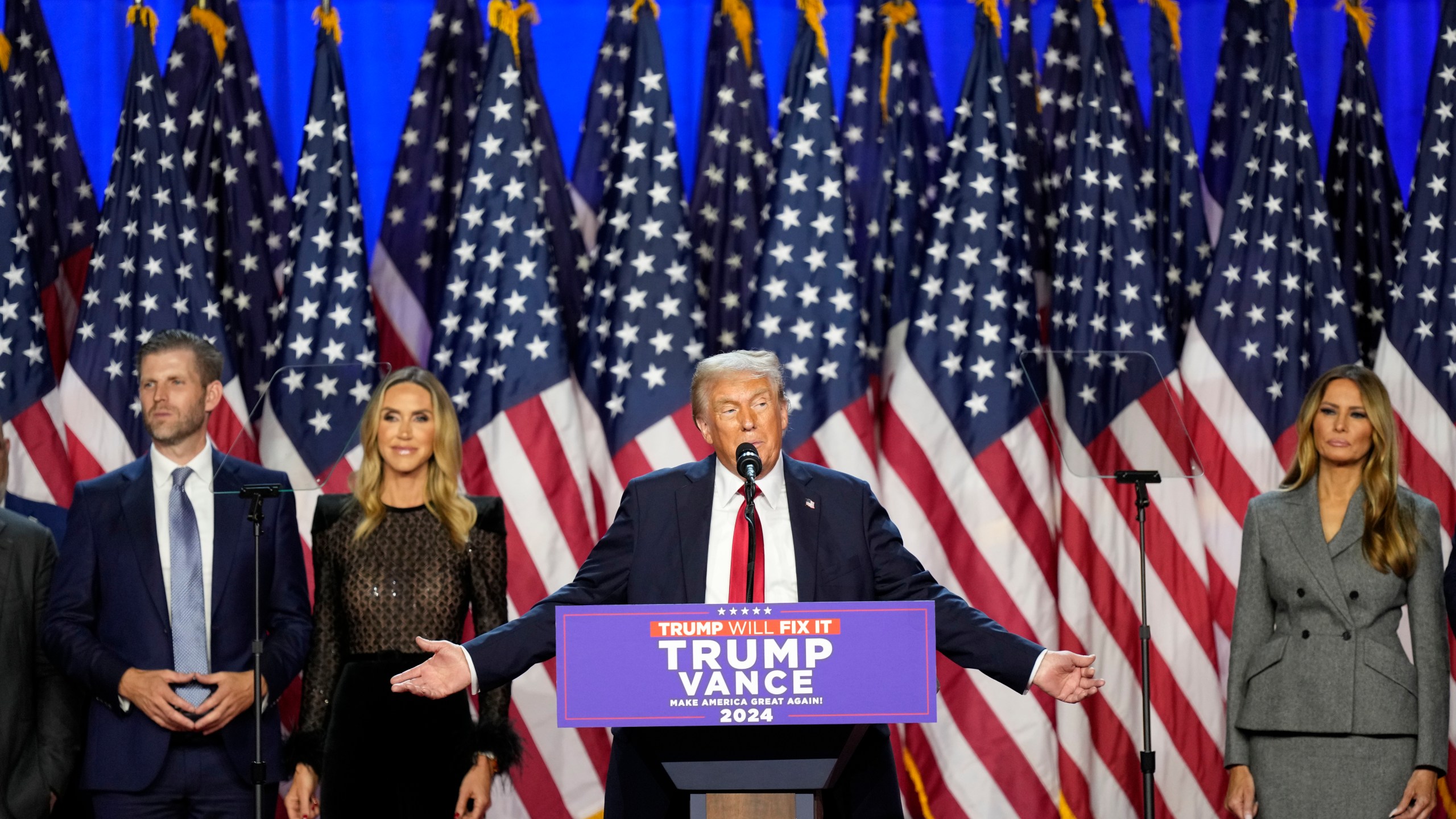 Republican presidential nominee former President Donald Trump speaks at an election night watch party Wednesday, Nov. 6, 2024, in West Palm Beach, Fla., as Eric Trump, Republican National Committee co-chair Lara Trump and Melania Trump listen. (AP Photo/Alex Brandon)