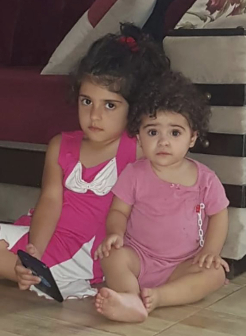 In this undated photo provided by Fatima Zayoun, Rahaf Skakye, 7, left, and her sister Ivana Skakye, 2, pose for photo earlier this year before both girls suffered severe burns in their home in southern Lebanon following an Israeli airstrike last September near their home in the village of Deir Qanoun al Nahr, south Lebanon. (Fatima Zayoun via AP)