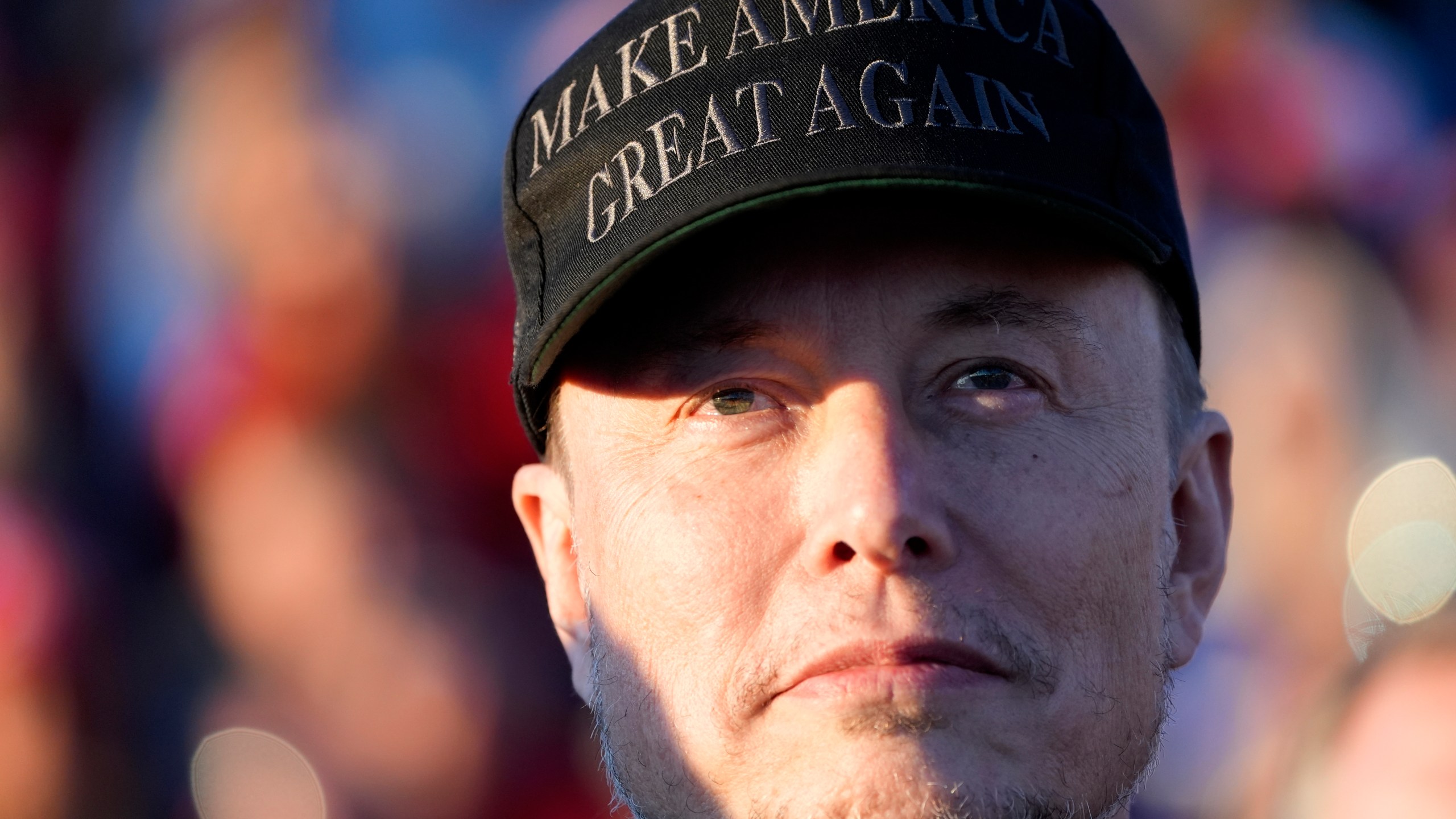 FILE - Tesla and SpaceX CEO Elon Musk listens as Republican presidential nominee former President Donald Trump speaks at a campaign event at the Butler Farm Show, Oct. 5, 2024, in Butler, Pa. (AP Photo/Alex Brandon, File)