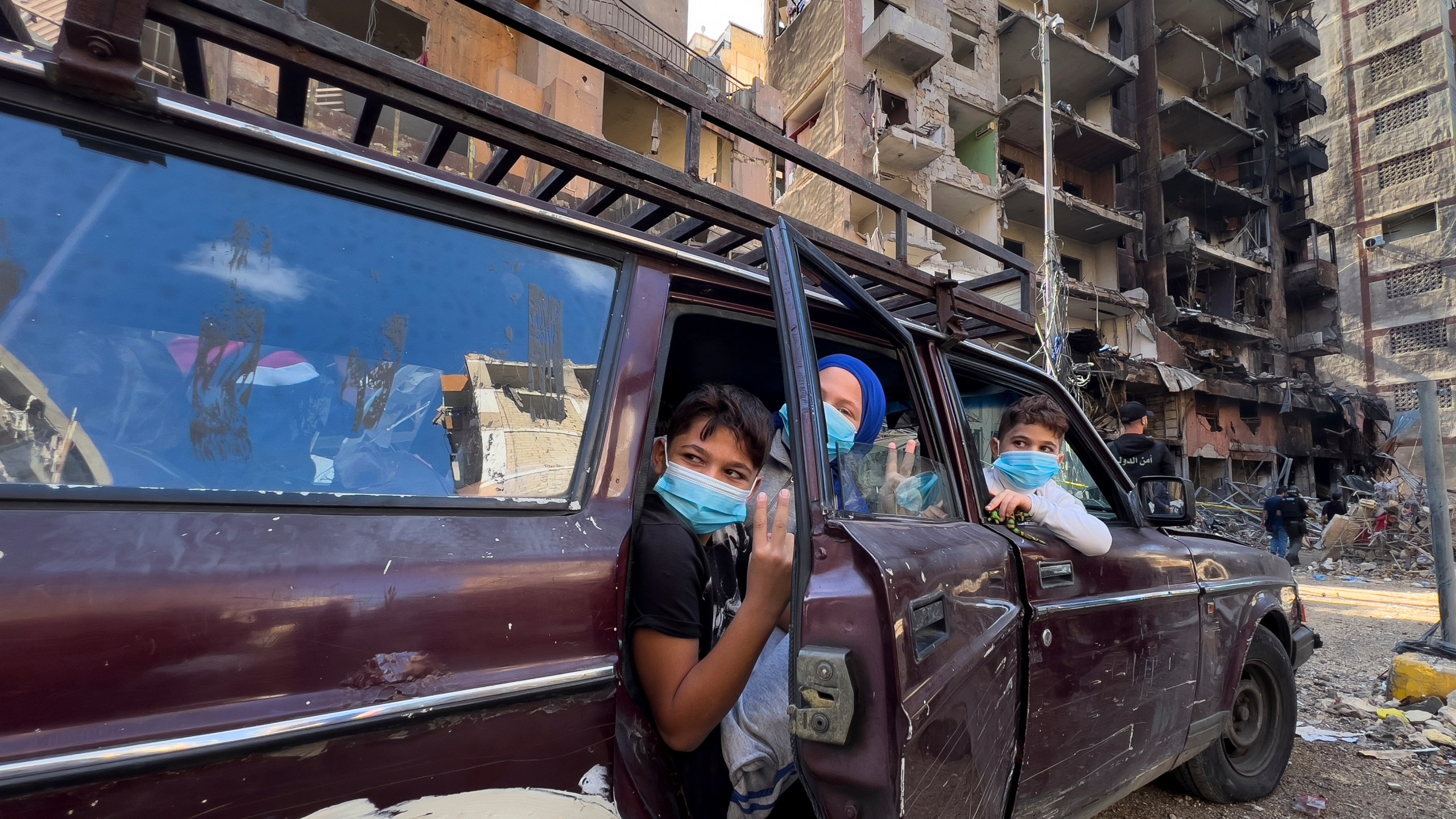 Children sit in a car as they wait their parents, who are collecting belongings from their house, which was destroyed by an Israeli airstrike in Dahiyeh, in the southern suburb of Beirut, Lebanon, Monday, Nov. 11, 2024. (AP Photo/Hussein Malla)