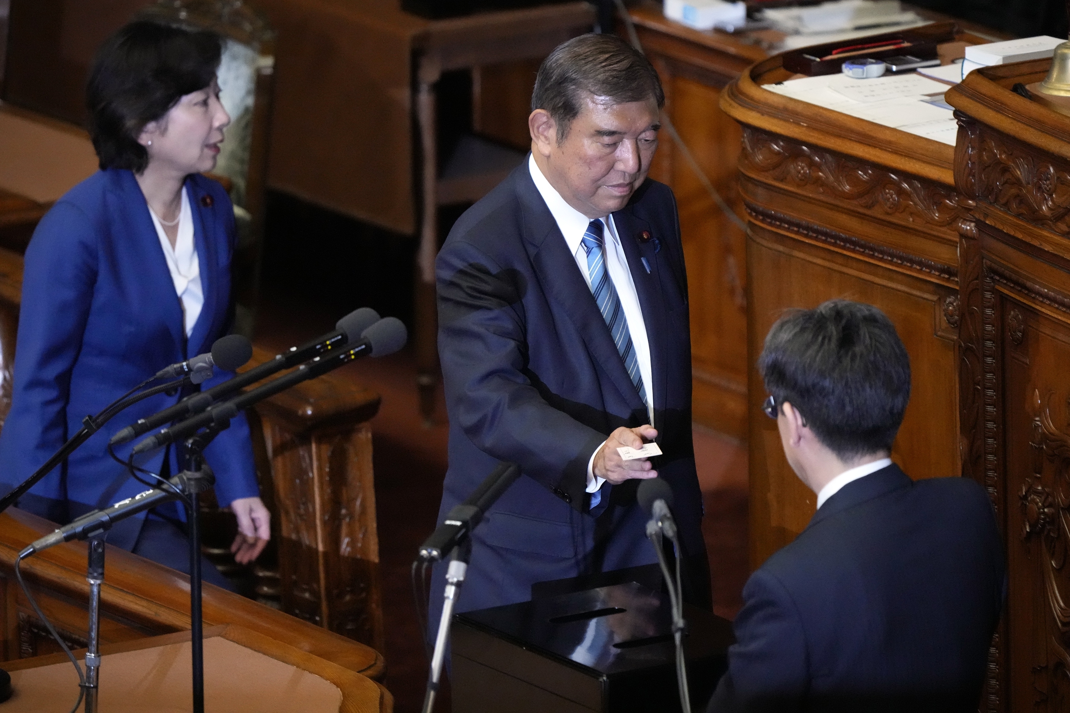 Japan's Prime Minister Shigeru Ishiba votes for the new prime minister at the parliament's lower house Monday, Nov. 11, 2024, in Tokyo. (AP Photo/Eugene Hoshiko)