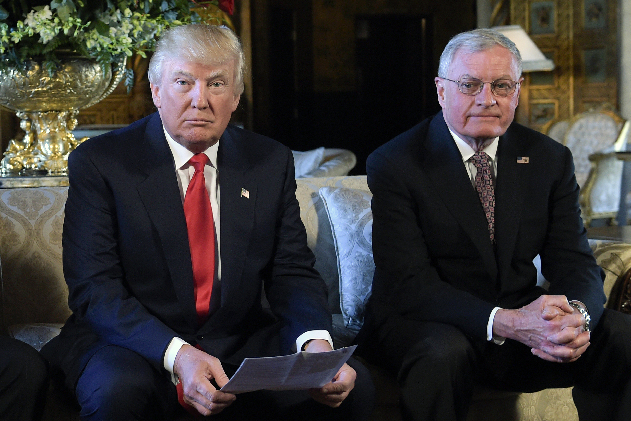 FILE - President Donald Trump, center, sits with retired Army Lt. Gen. Keith Kellogg, right, at Trump's Mar-a-Lago estate in Palm Beach, Fla., Feb. 20, 2017. President-elect Donald Trump’s choice for defense secretary is still up in the air, but it’s a sure bet he will look to pick a loyalist following his tumultuous first term. (AP Photo/Susan Walsh, File)