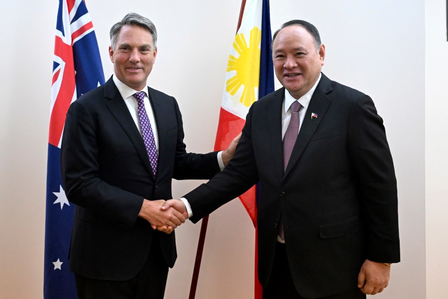 Australian Deputy Prime Minister Richard Marles, left, shakes hands with Philippine Secretary of National Defense Gilberto C. Teodoro Jr. during the inaugural Australia-Philippines Defence Ministers' Meeting at Parliament House in Canberra, Tuesday, Nov. 12, 2024. (Lukas Coch/AAP Image via AP)