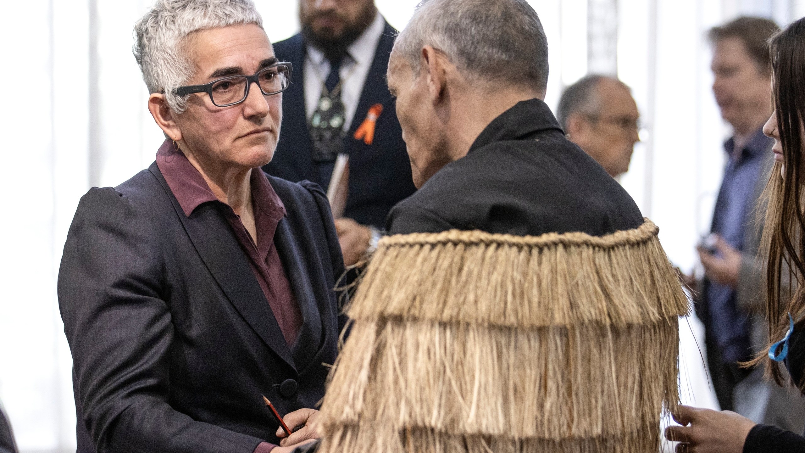 Solicitor-General Una Jagose, left, speaks with survivor Toni Jarvis following Prime Minister Christopher Luxon's "formal and unreserved" apology in Parliament for the widespread abuse, torture and neglect of hundreds of thousands of children and vulnerable adults in care, in Wellington, New Zealand Tuesday, Nov. 12, 2024. (Monique Ford/Stuff via AP)