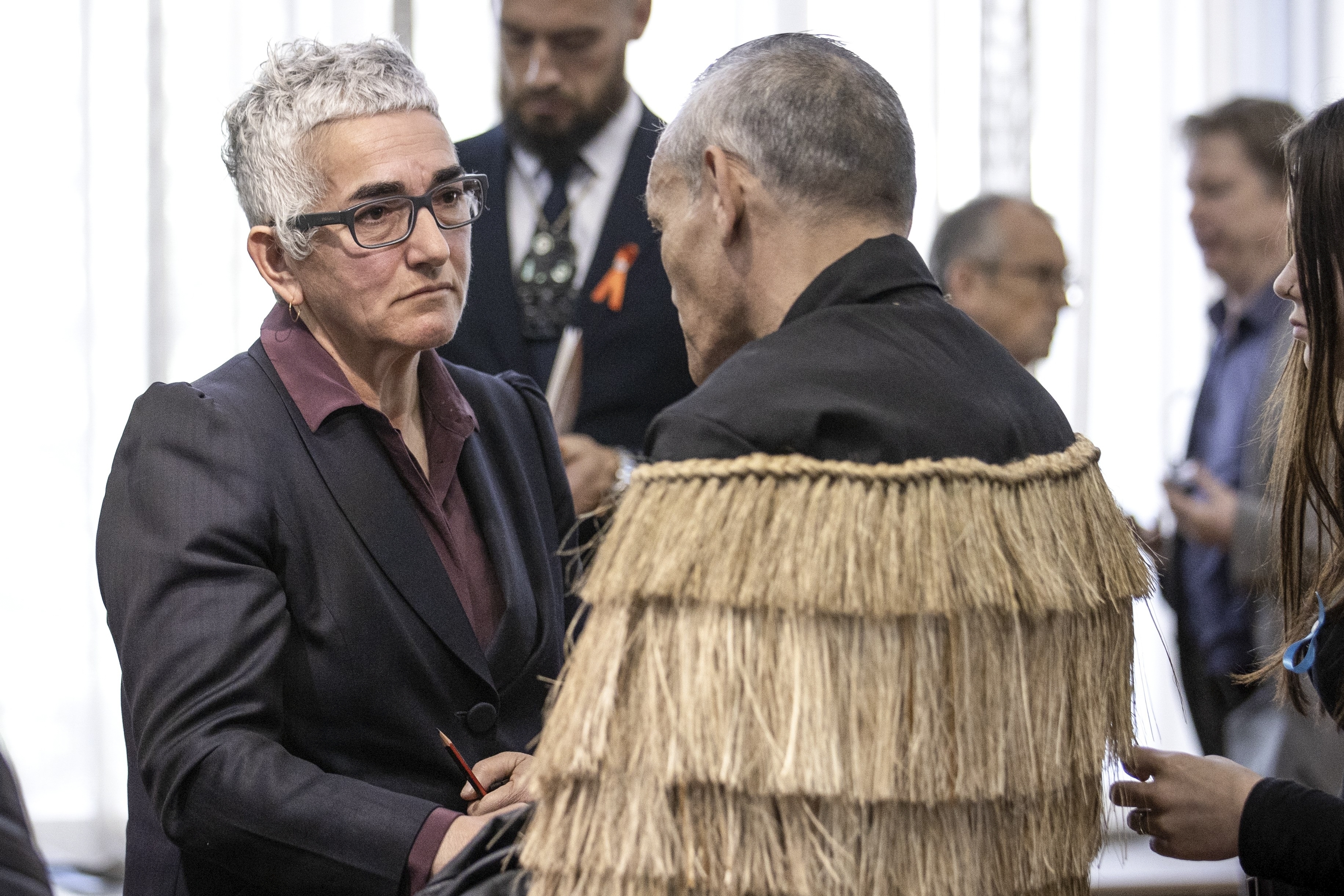 Solicitor-General Una Jagose, left, speaks with survivor Toni Jarvis following Prime Minister Christopher Luxon's "formal and unreserved" apology in Parliament for the widespread abuse, torture and neglect of hundreds of thousands of children and vulnerable adults in care, in Wellington, New Zealand Tuesday, Nov. 12, 2024. (Monique Ford/Stuff via AP)