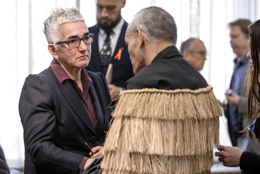 Solicitor-General Una Jagose, left, speaks with survivor Toni Jarvis following Prime Minister Christopher Luxon's "formal and unreserved" apology in Parliament for the widespread abuse, torture and neglect of hundreds of thousands of children and vulnerable adults in care, in Wellington, New Zealand Tuesday, Nov. 12, 2024. (Monique Ford/Stuff via AP)